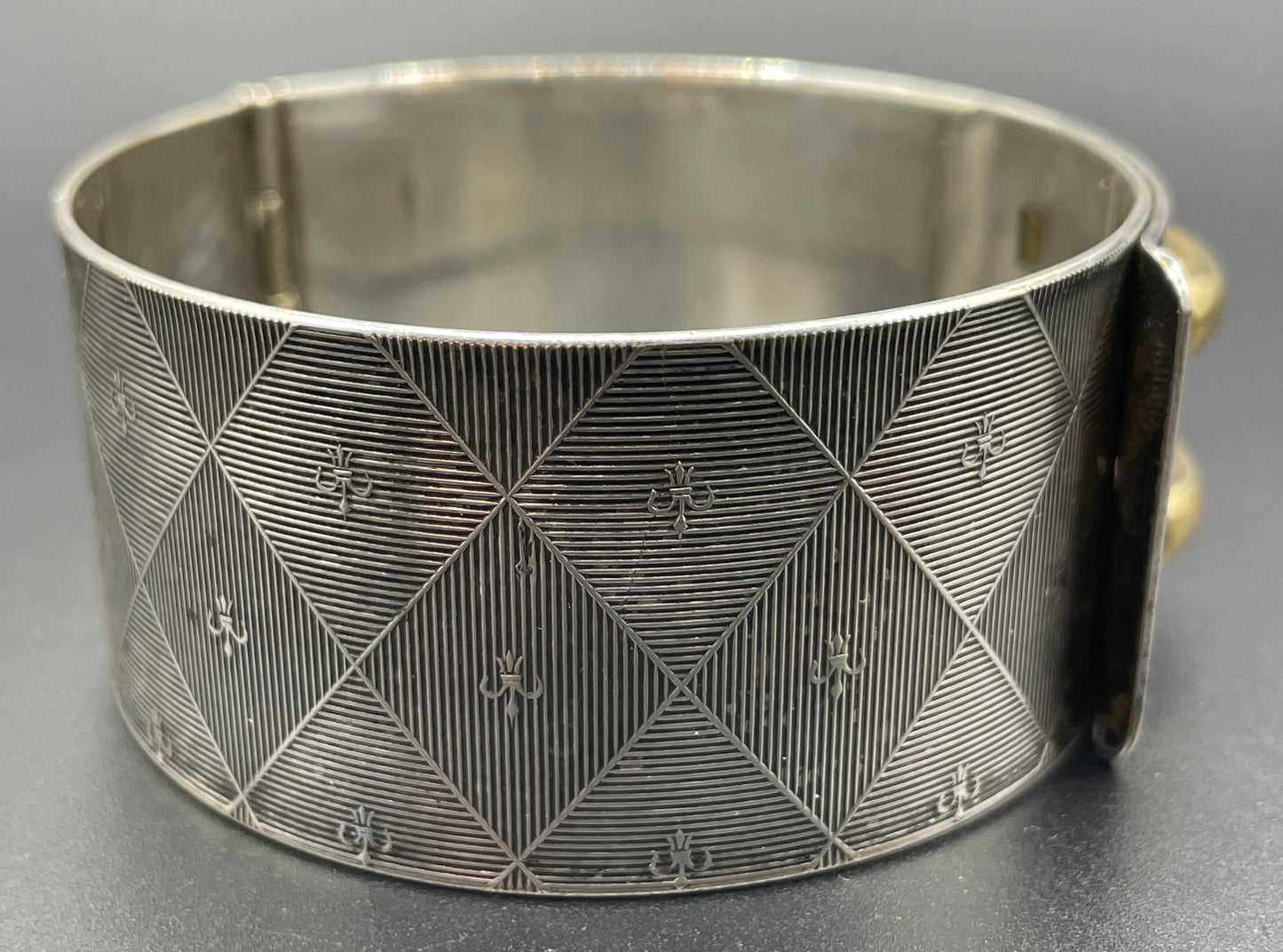 Vintage signed Kigu Art Deco engine turned machine age gold and silver tone wide bangle bracelet hinged cuff, fleur de lys Bauhaus design