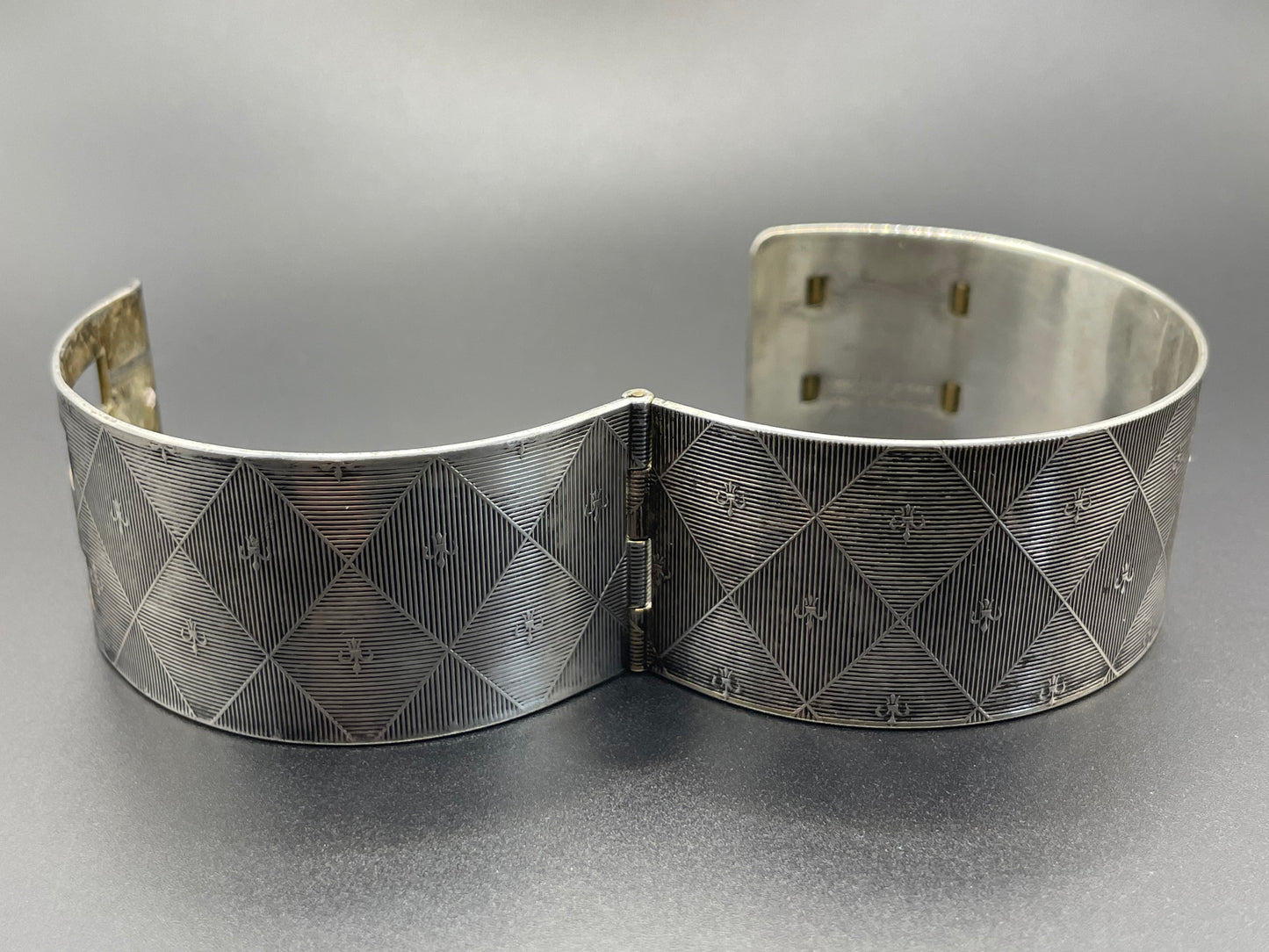 Vintage signed Kigu Art Deco engine turned machine age gold and silver tone wide bangle bracelet hinged cuff, fleur de lys Bauhaus design