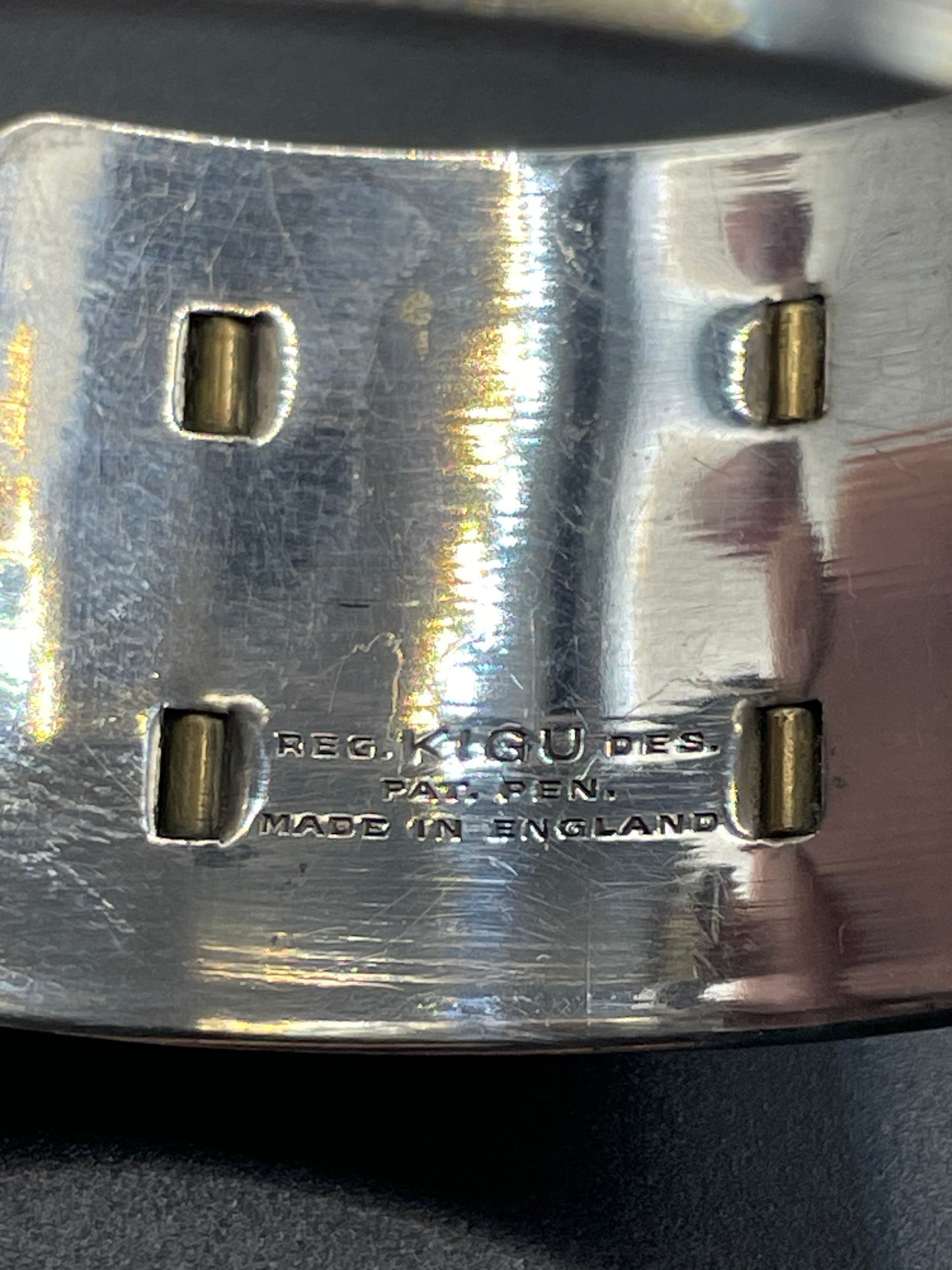 Vintage signed Kigu Art Deco engine turned machine age gold and silver tone wide bangle bracelet hinged cuff, fleur de lys Bauhaus design
