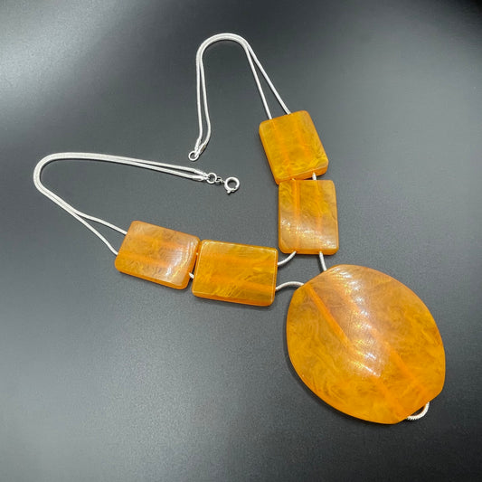 Vintage Art Deco marbled orange galalith huge bead necklace with double strand silver tone chrome machine age snake chains