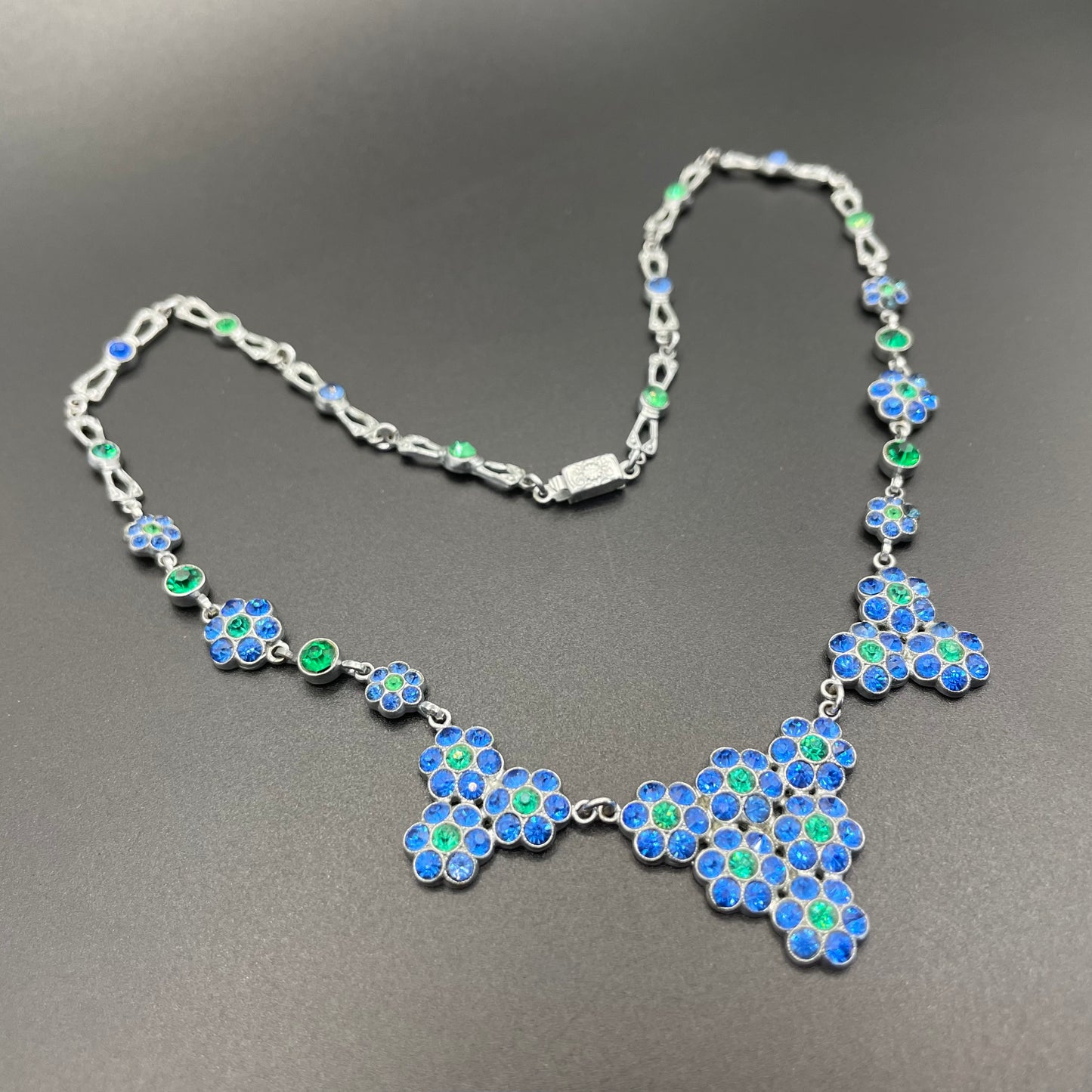 Vintage bright blue and green paste rhinestone and shiny silver tone necklace, 1930s to 1940s machine age links, floral design