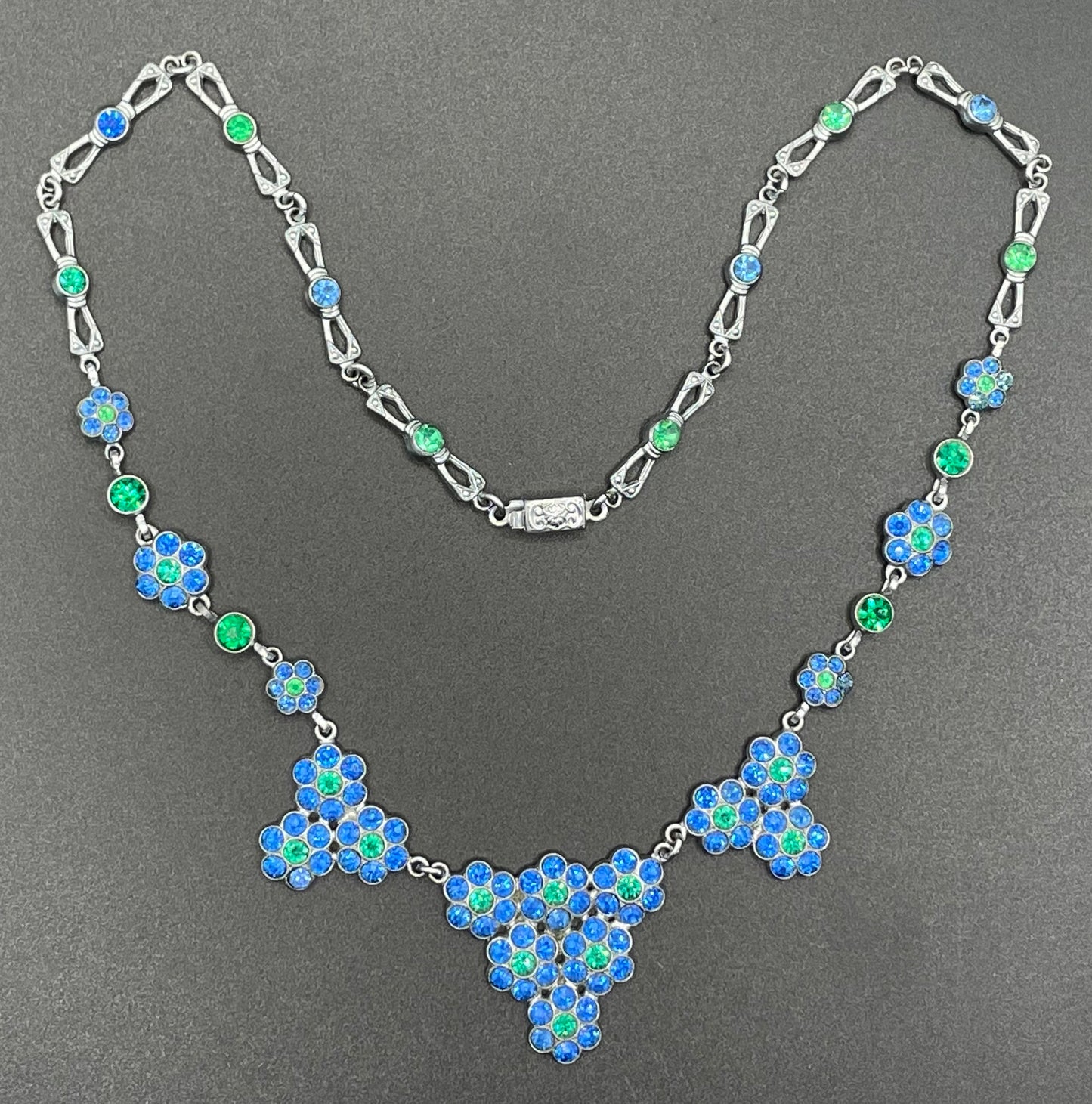 Vintage bright blue and green paste rhinestone and shiny silver tone necklace, 1930s to 1940s machine age links, floral design