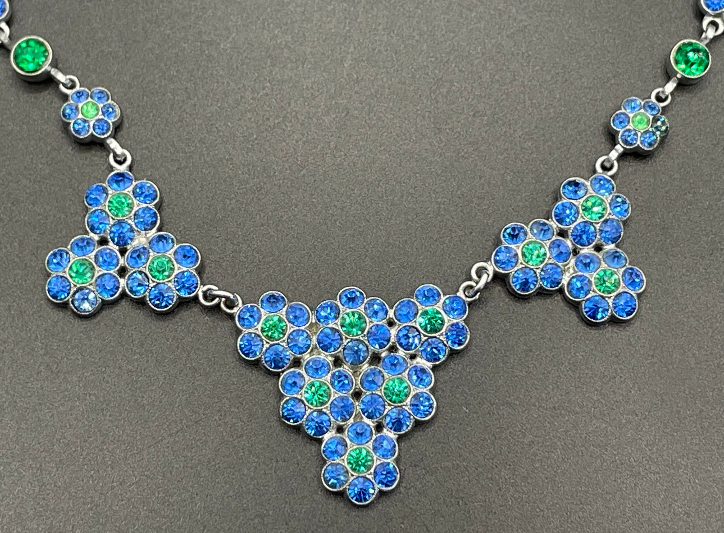 Vintage bright blue and green paste rhinestone and shiny silver tone necklace, 1930s to 1940s machine age links, floral design