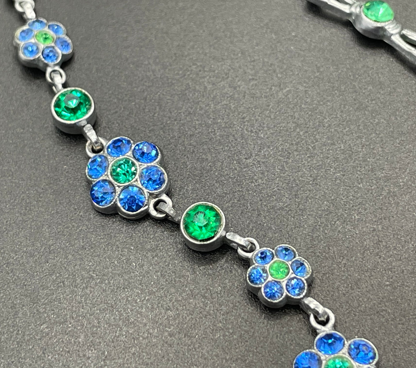 Vintage bright blue and green paste rhinestone and shiny silver tone necklace, 1930s to 1940s machine age links, floral design