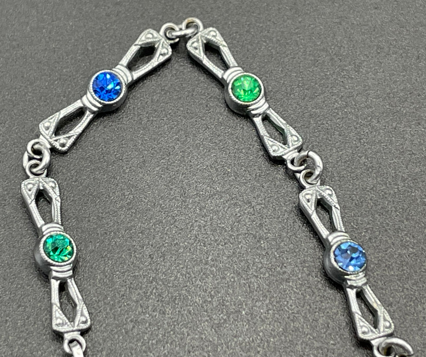 Vintage bright blue and green paste rhinestone and shiny silver tone necklace, 1930s to 1940s machine age links, floral design