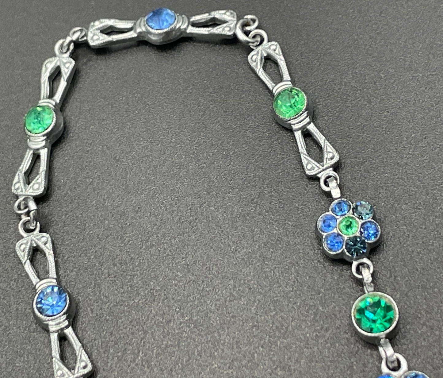 Vintage bright blue and green paste rhinestone and shiny silver tone necklace, 1930s to 1940s machine age links, floral design