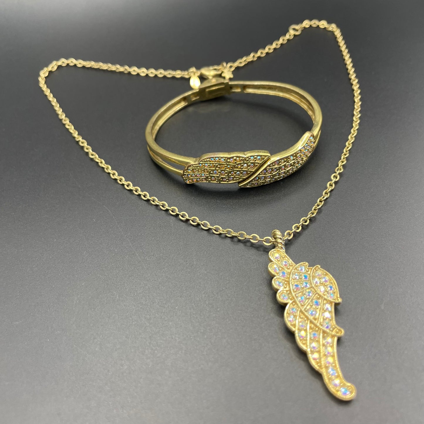 Vintage signed Kirk's Folly angel wing motif pendant necklace and clamper bangle set, in gold tone with aurora borealis AB rhinestones