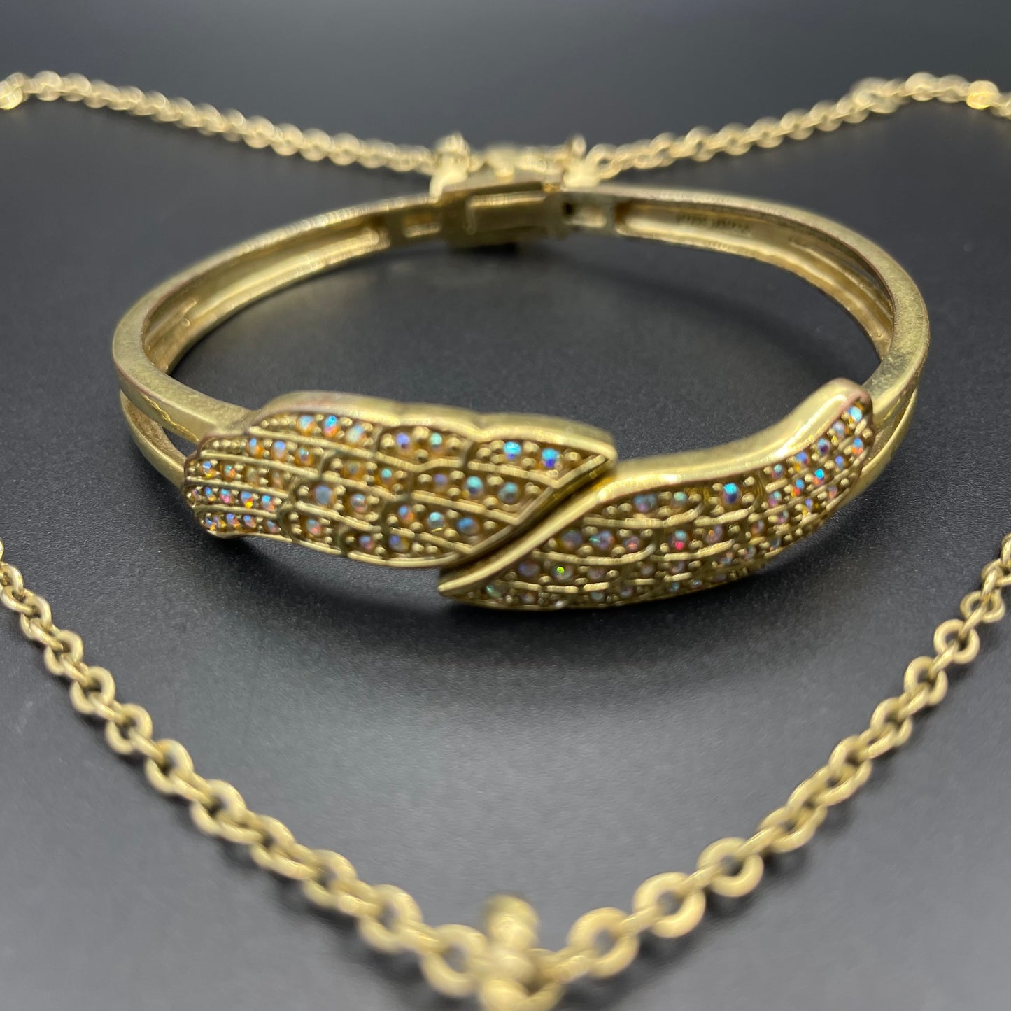 Vintage signed Kirk's Folly angel wing motif pendant necklace and clamper bangle set, in gold tone with aurora borealis AB rhinestones