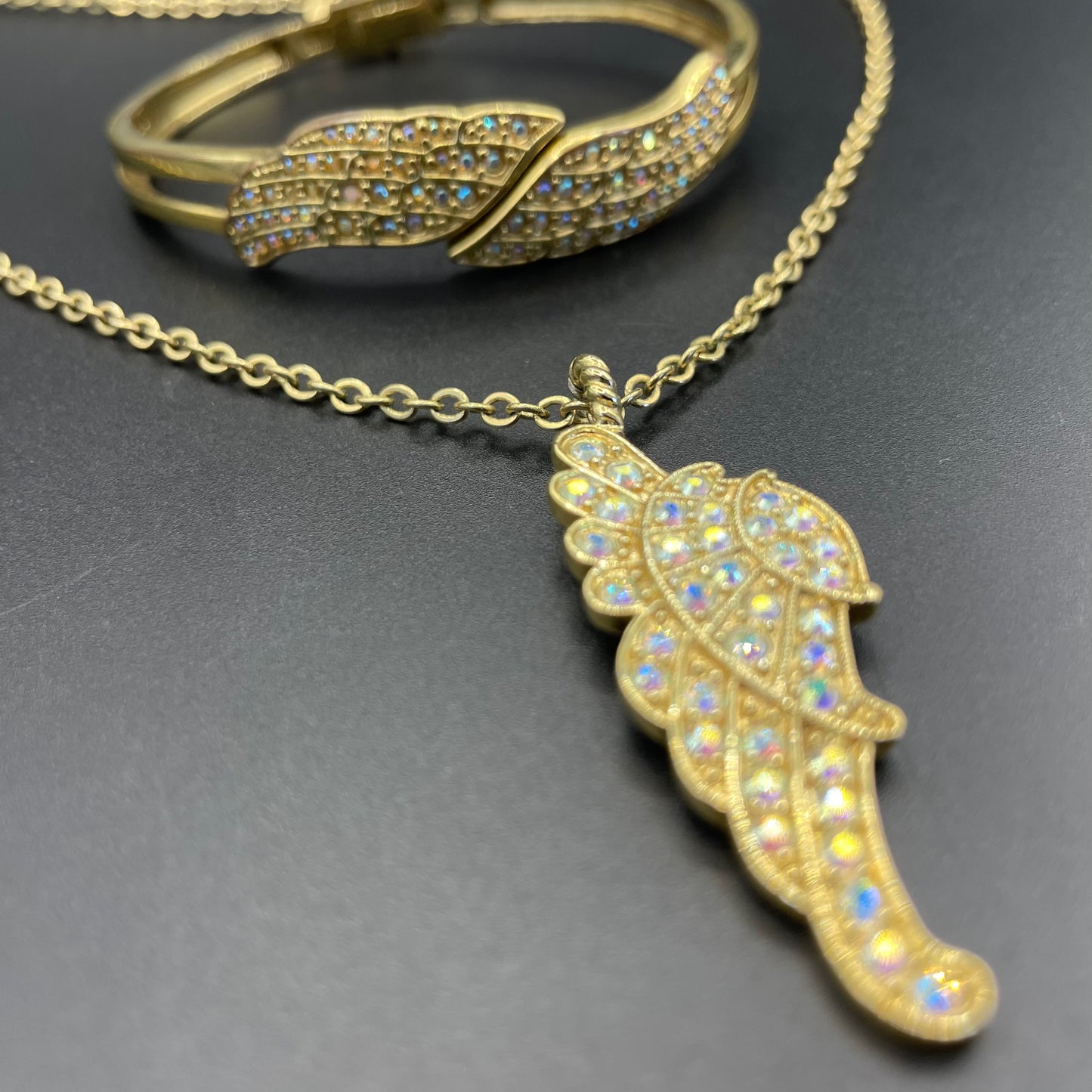 Vintage signed Kirk's Folly angel wing motif pendant necklace and clamper bangle set, in gold tone with aurora borealis AB rhinestones