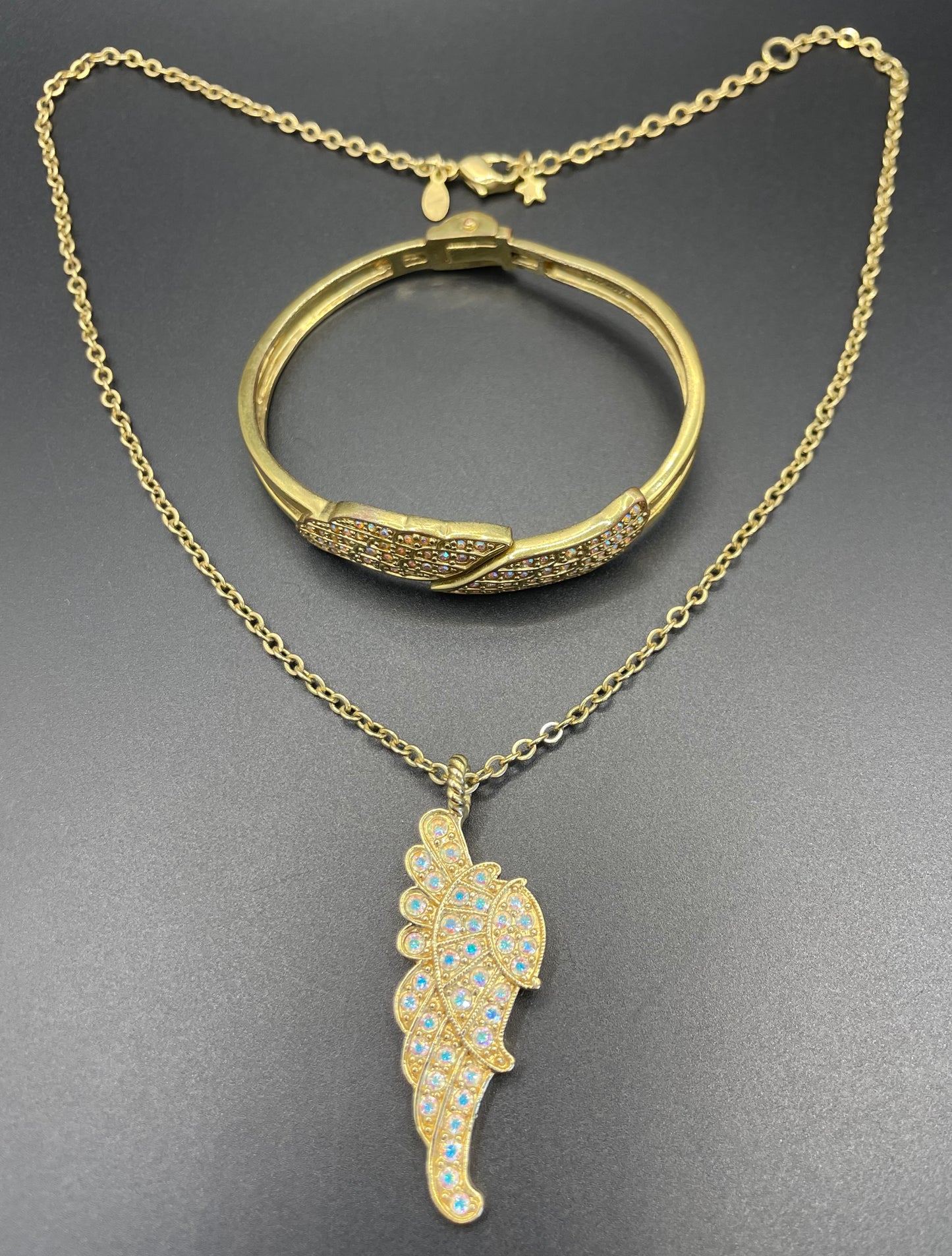 Vintage signed Kirk's Folly angel wing motif pendant necklace and clamper bangle set, in gold tone with aurora borealis AB rhinestones