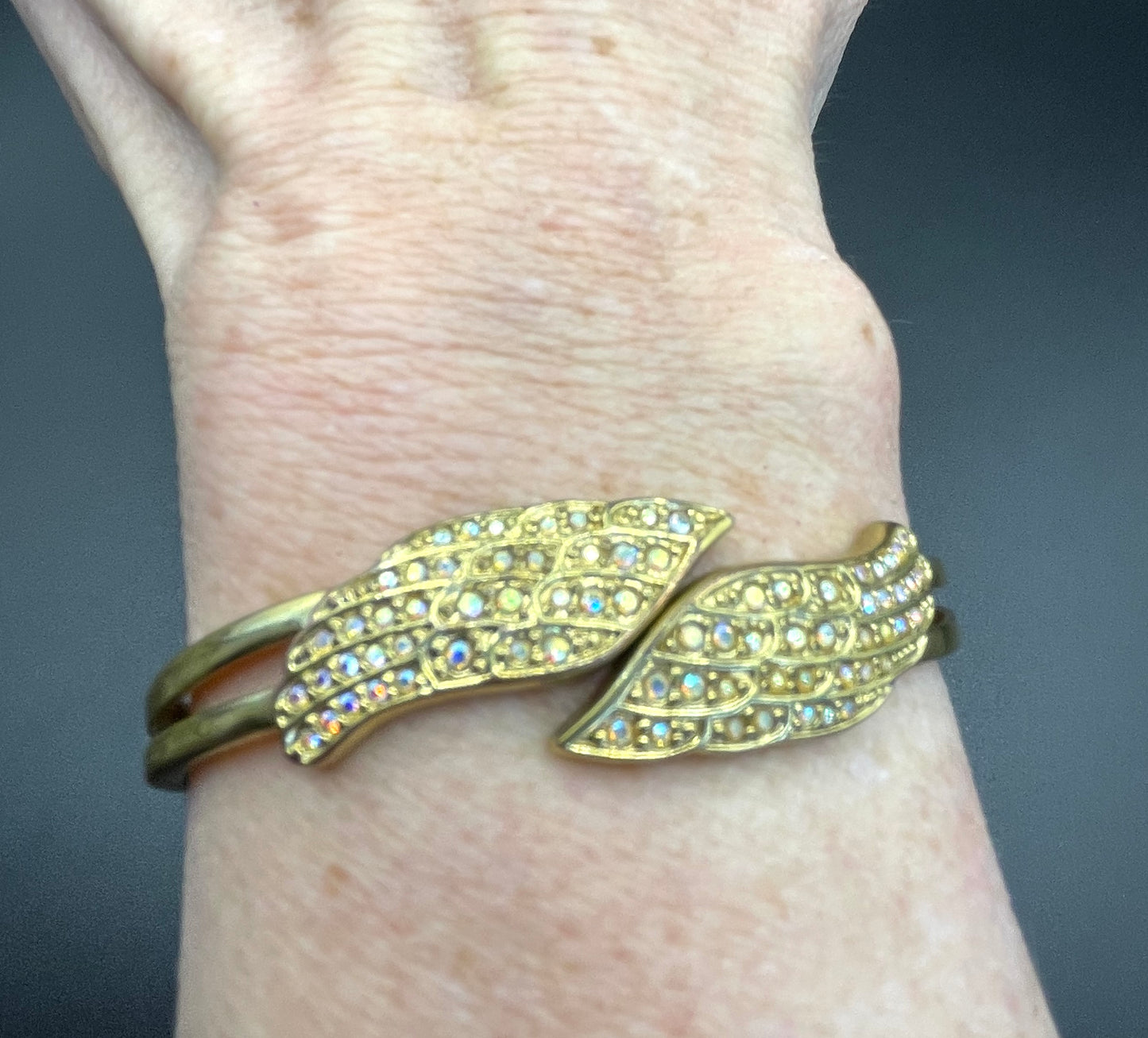 Vintage signed Kirk's Folly angel wing motif pendant necklace and clamper bangle set, in gold tone with aurora borealis AB rhinestones
