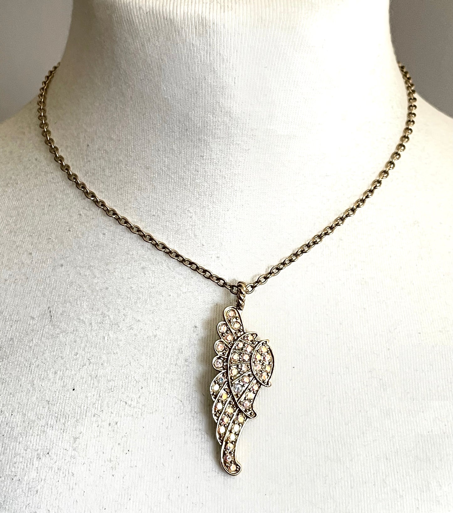 Vintage signed Kirk's Folly angel wing motif pendant necklace and clamper bangle set, in gold tone with aurora borealis AB rhinestones