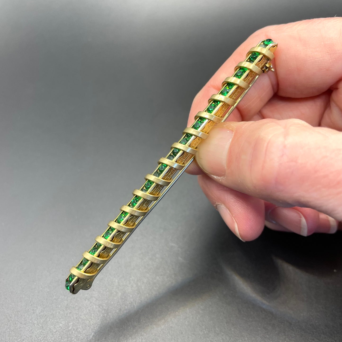 Vintage Schreiber & Hiller Art Deco channel set paste emerald green rhinestone  and gold tone machine age long bar brooch
