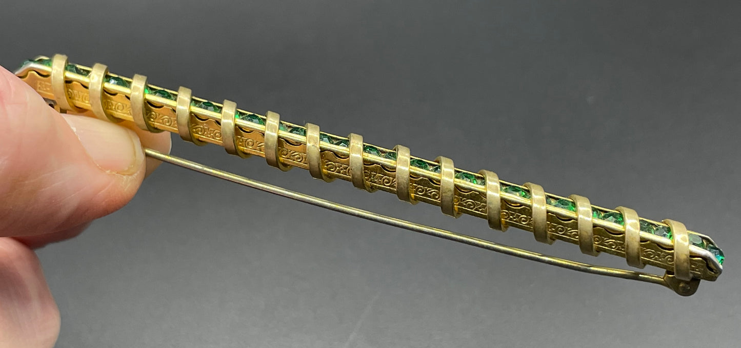 Vintage Schreiber & Hiller Art Deco channel set paste emerald green rhinestone  and gold tone machine age long bar brooch