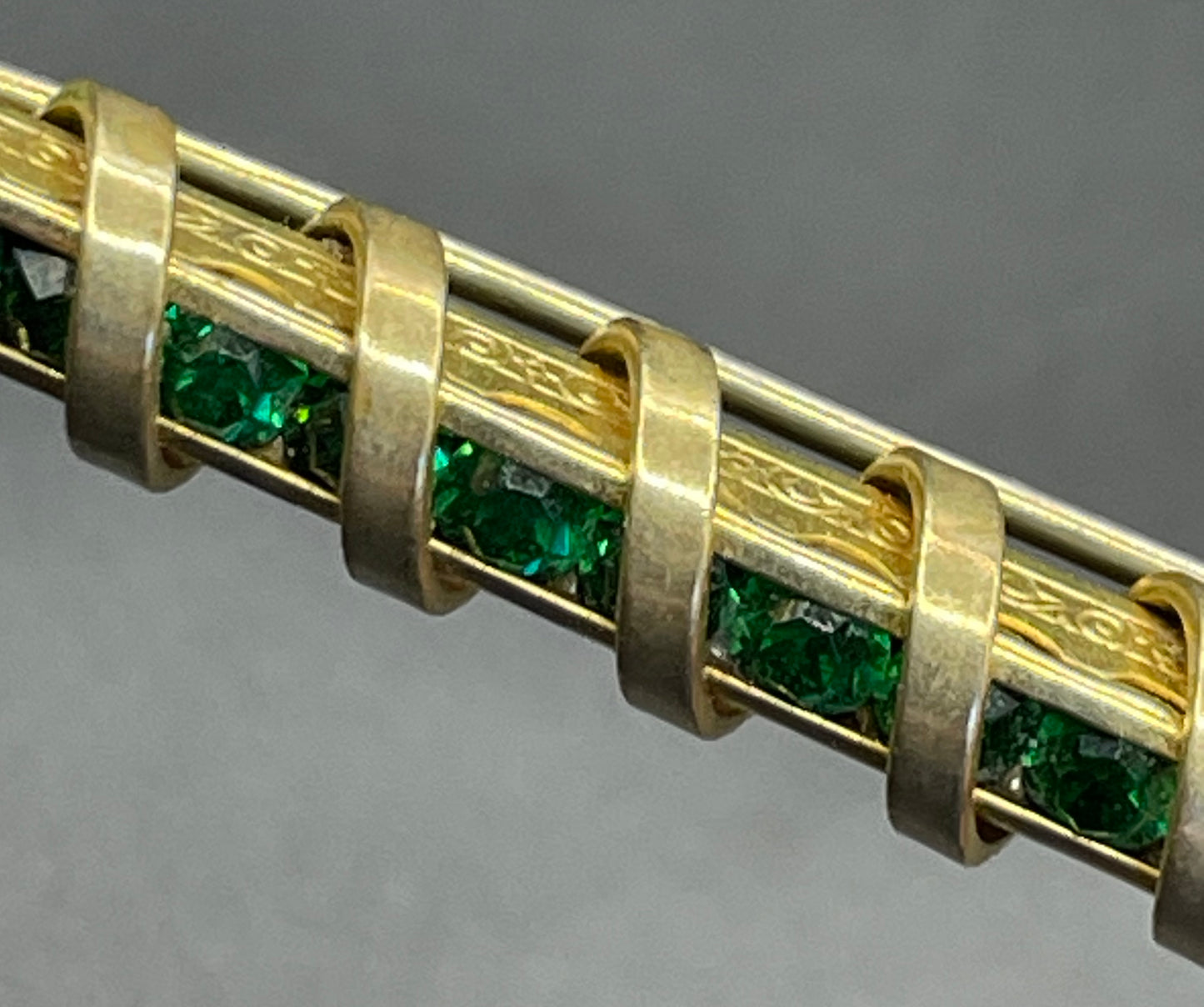 Vintage Schreiber & Hiller Art Deco channel set paste emerald green rhinestone  and gold tone machine age long bar brooch
