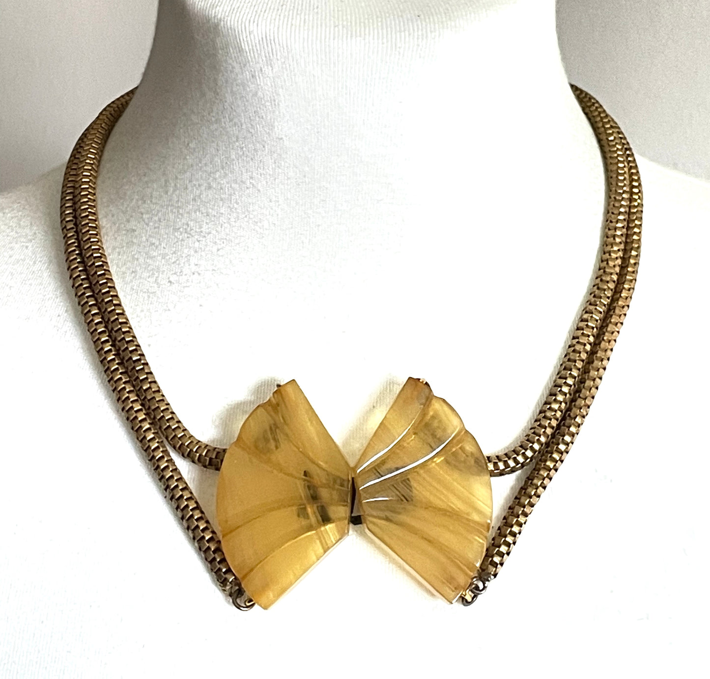 Vintage Art Deco marbled yellow galalith buckle necklace with double strand antique gold tone machine age snake chains, front fastening
