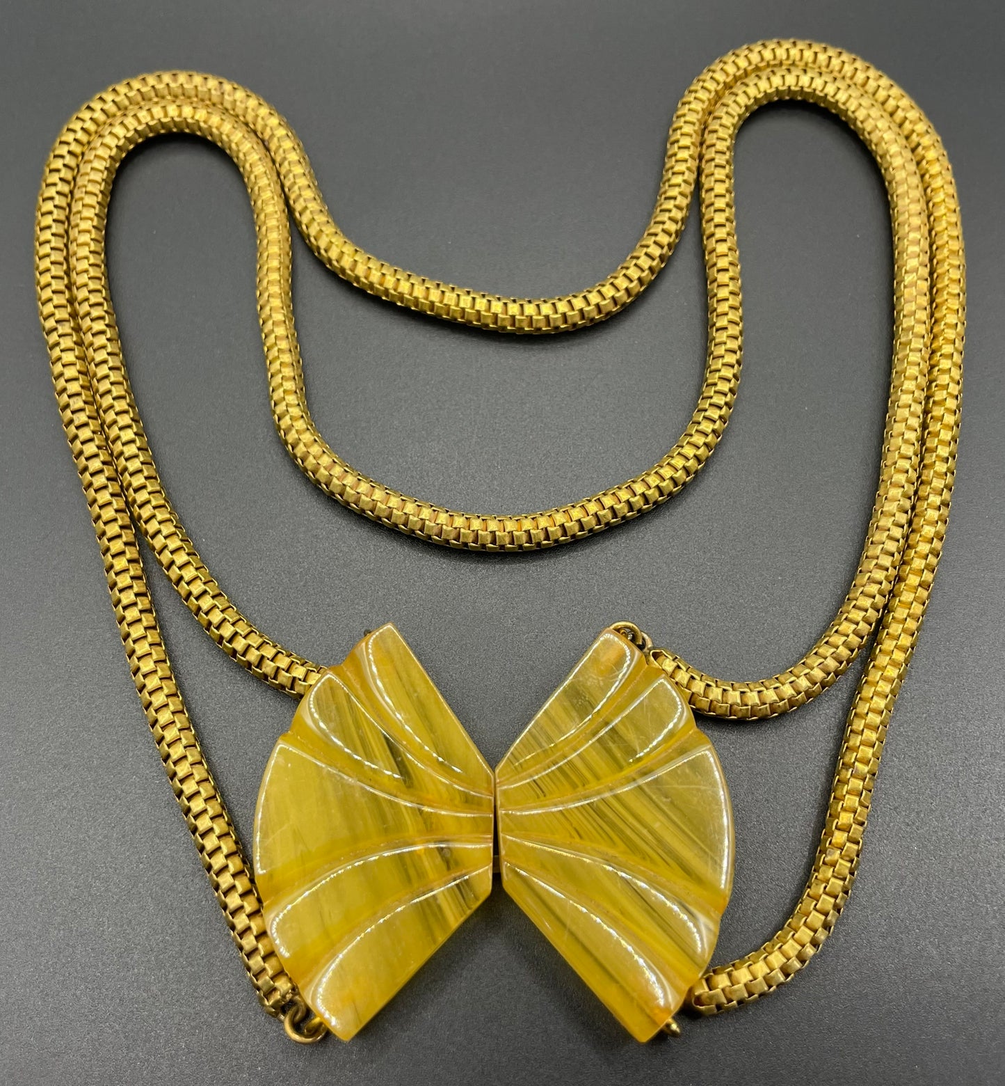 Vintage Art Deco marbled yellow galalith buckle necklace with double strand antique gold tone machine age snake chains, front fastening