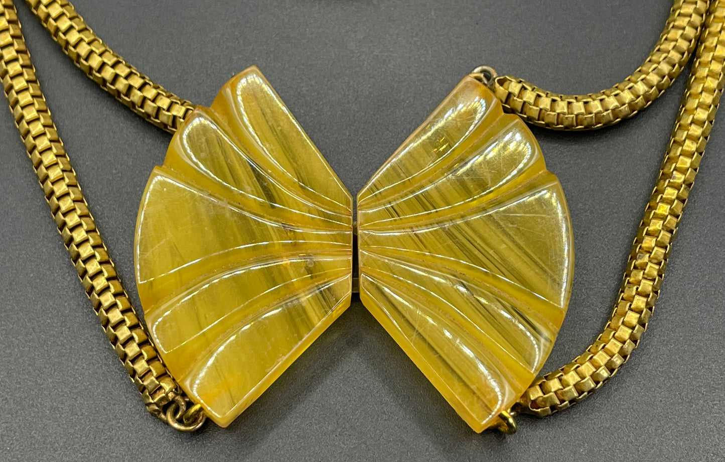 Vintage Art Deco marbled yellow galalith buckle necklace with double strand antique gold tone machine age snake chains, front fastening