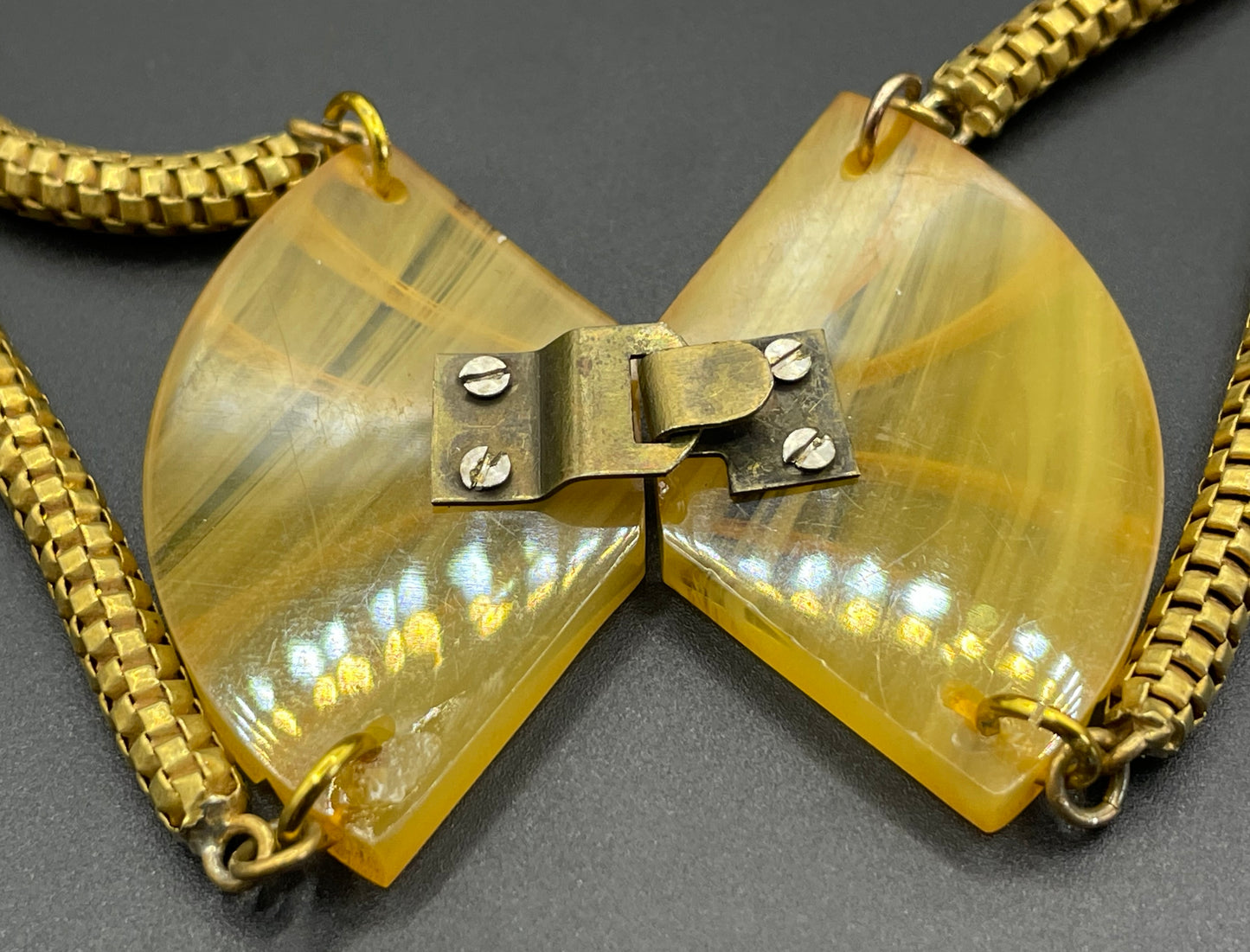 Vintage Art Deco marbled yellow galalith buckle necklace with double strand antique gold tone machine age snake chains, front fastening