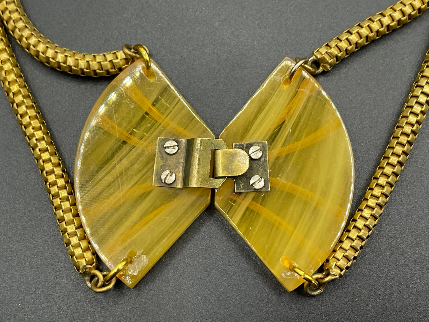 Vintage Art Deco marbled yellow galalith buckle necklace with double strand antique gold tone machine age snake chains, front fastening