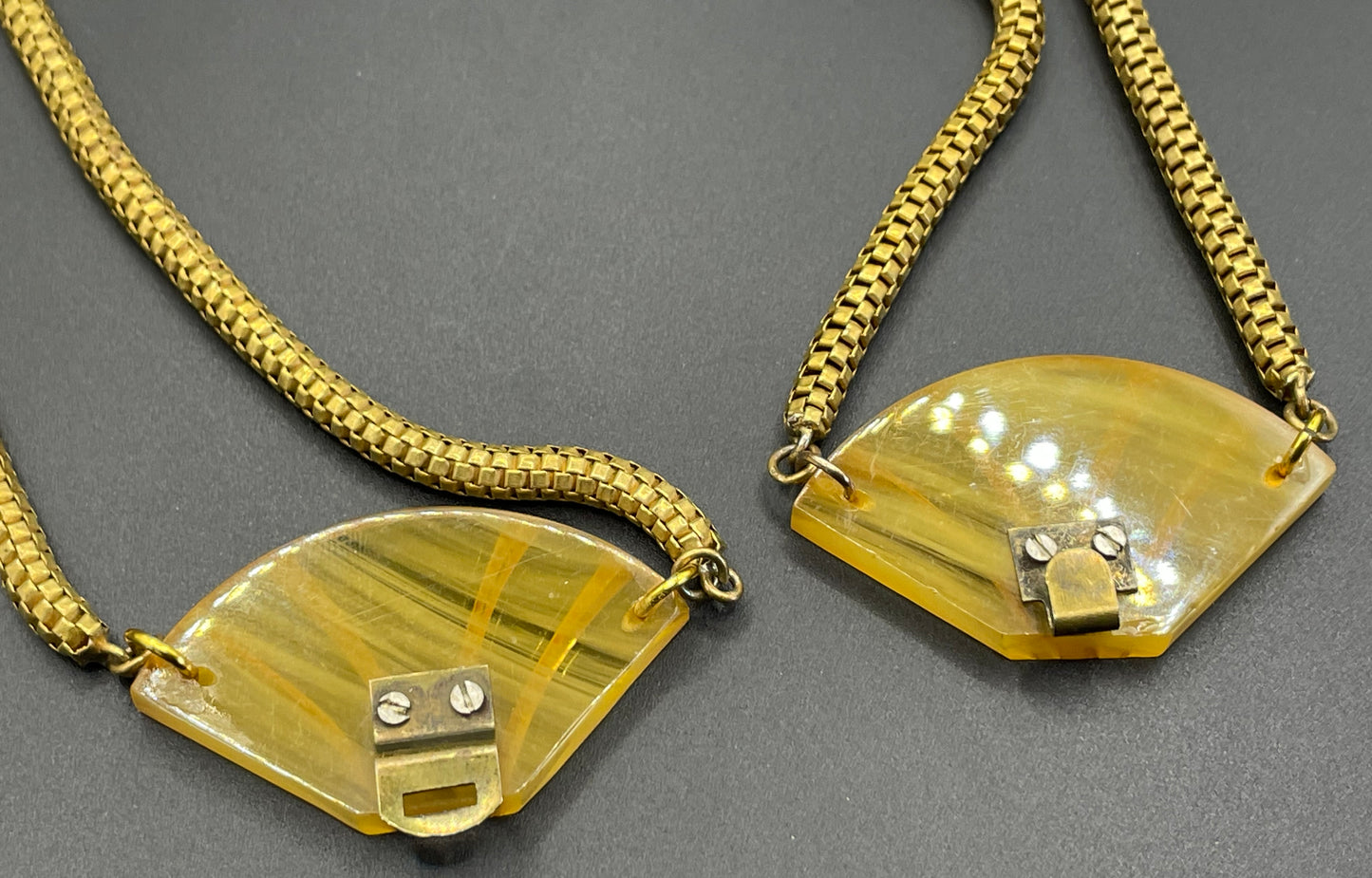 Vintage Art Deco marbled yellow galalith buckle necklace with double strand antique gold tone machine age snake chains, front fastening