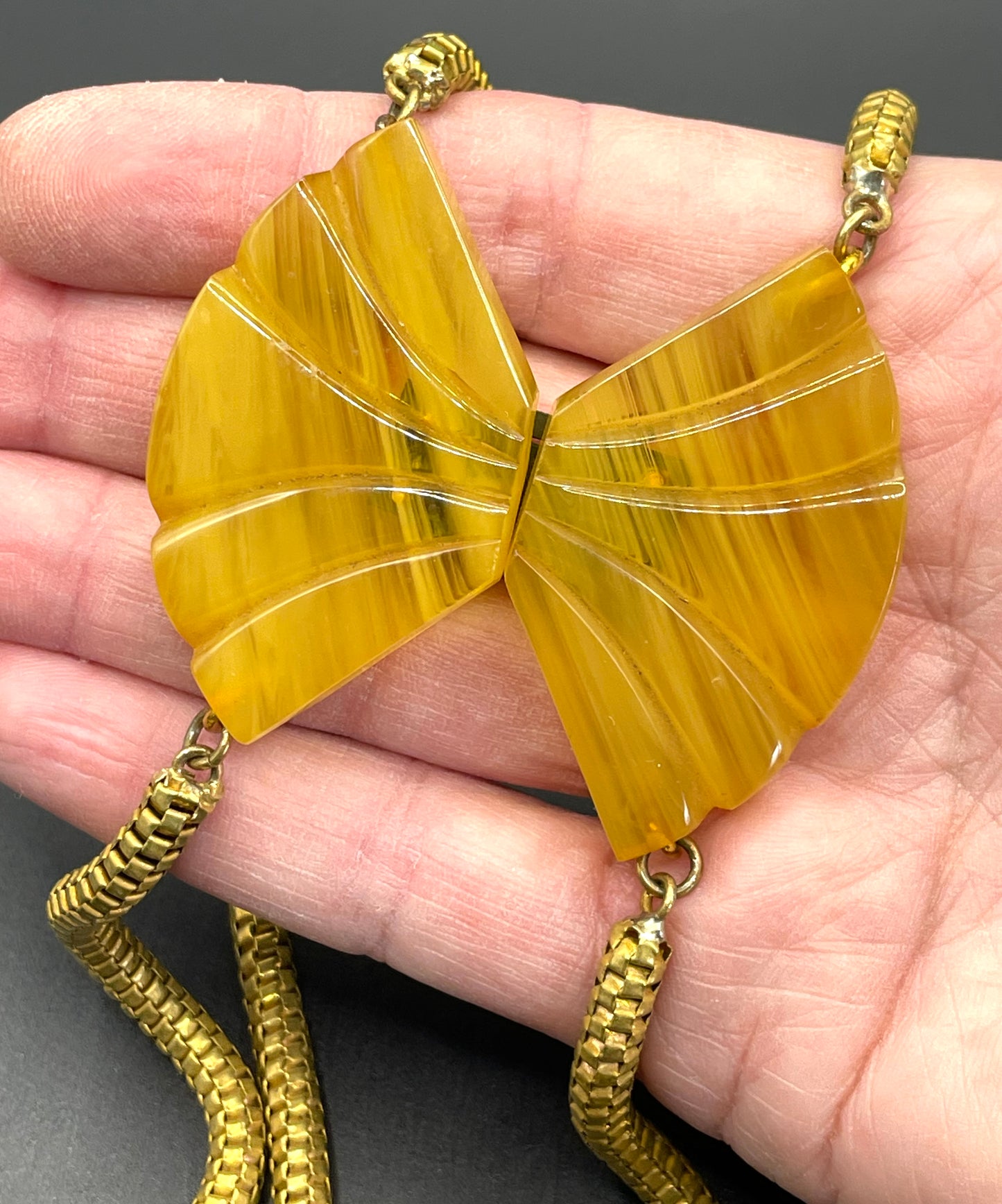 Vintage Art Deco marbled yellow galalith buckle necklace with double strand antique gold tone machine age snake chains, front fastening