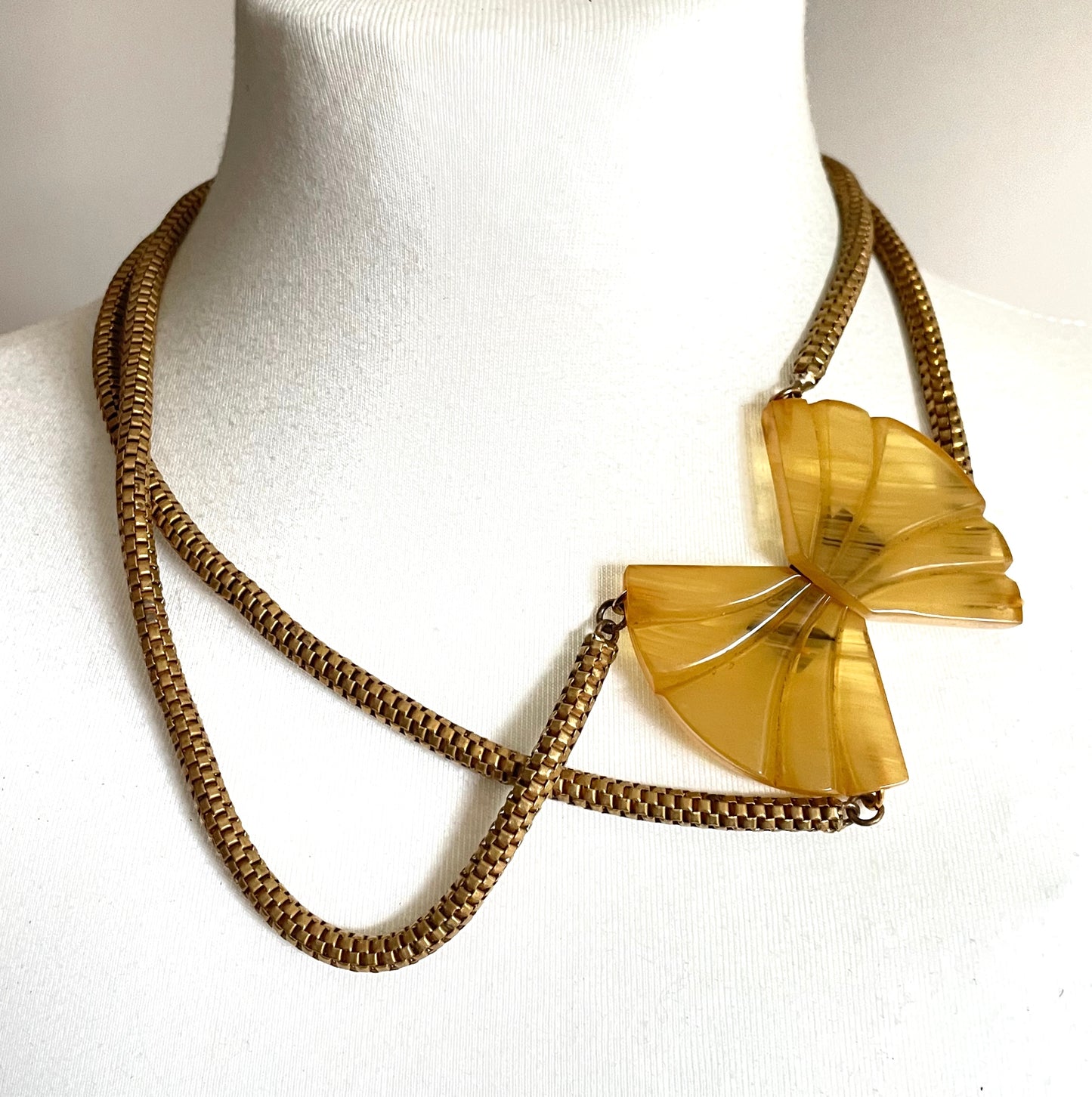Vintage Art Deco marbled yellow galalith buckle necklace with double strand antique gold tone machine age snake chains, front fastening