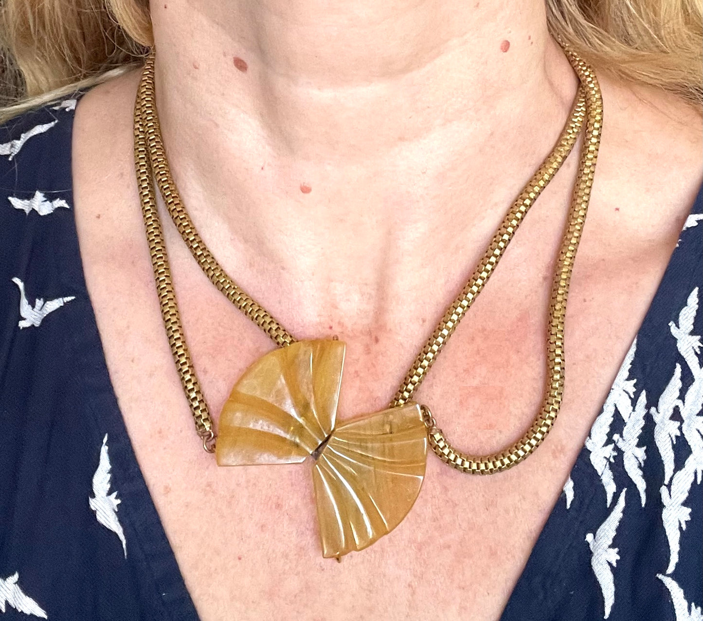 Vintage Art Deco marbled yellow galalith buckle necklace with double strand antique gold tone machine age snake chains, front fastening