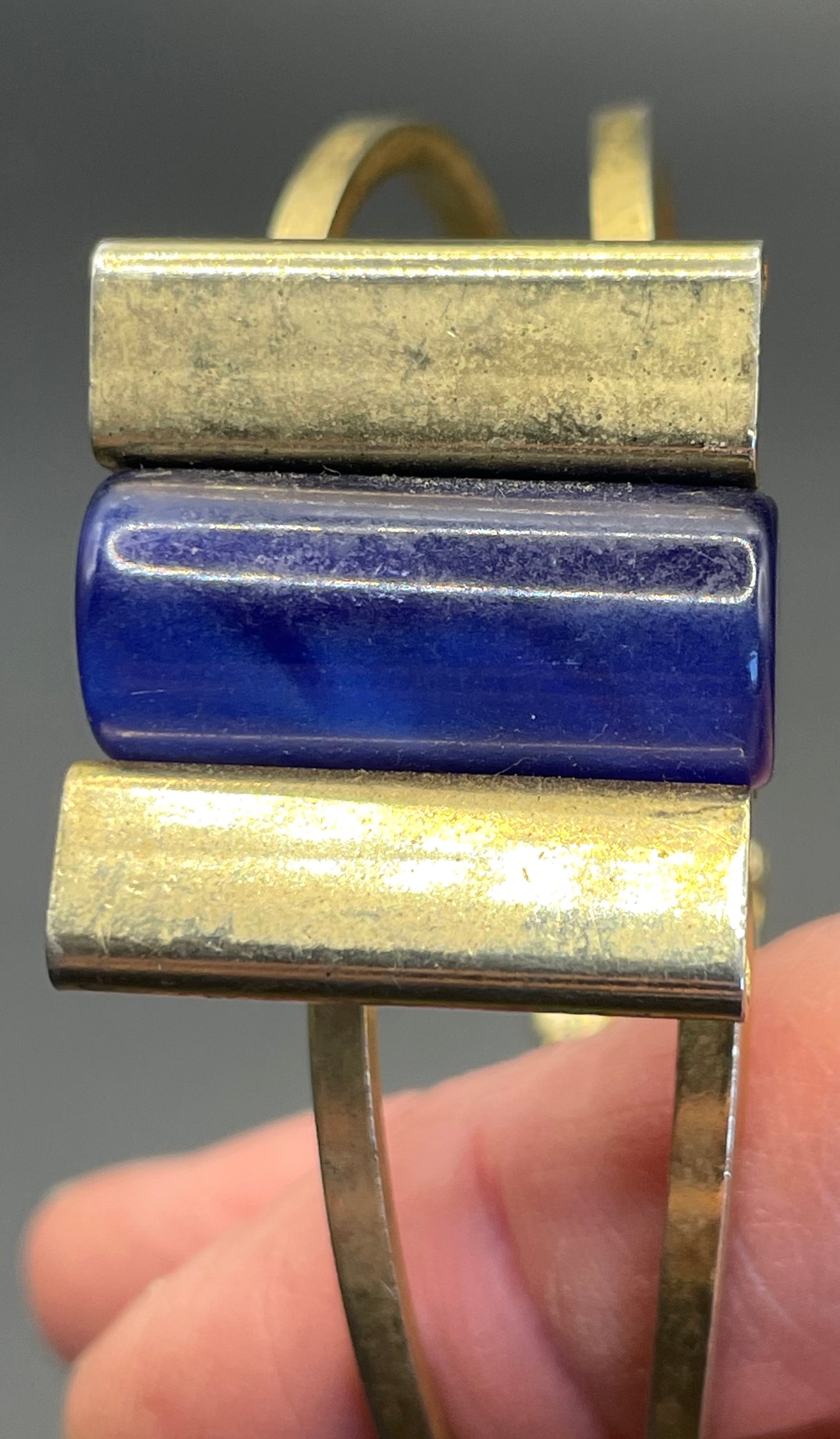 Vintage Jakob Bengel Art Deco machine age clamper bangle in shiny gold tone with a rich blue galalith cylinder