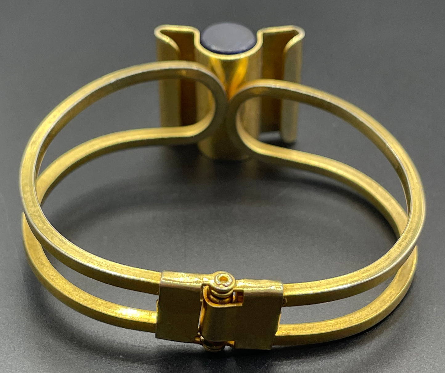 Vintage Jakob Bengel Art Deco machine age clamper bangle in shiny gold tone with a rich blue galalith cylinder