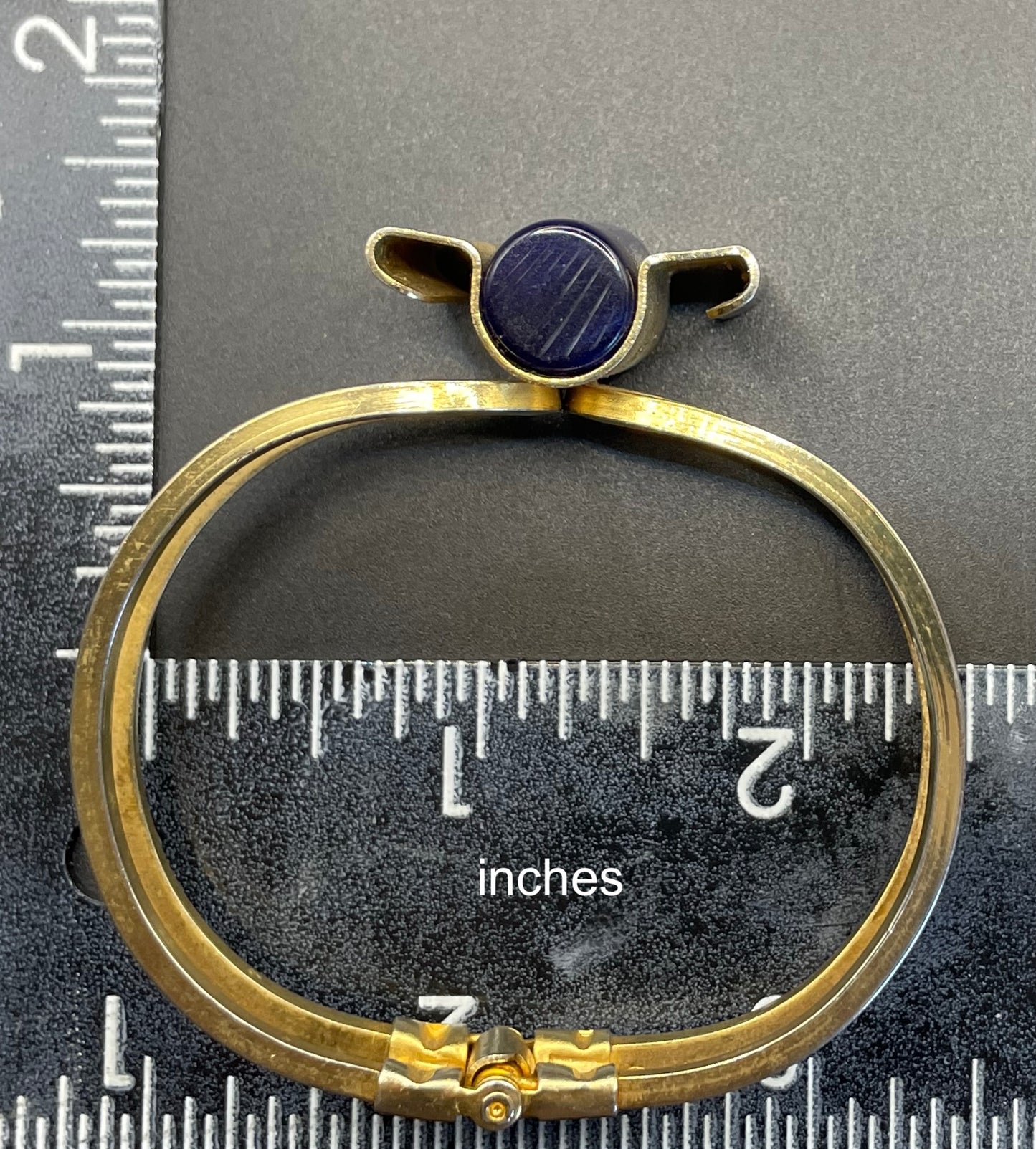 Vintage Jakob Bengel Art Deco machine age clamper bangle in shiny gold tone with a rich blue galalith cylinder
