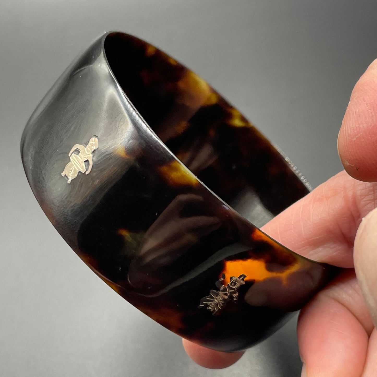 Antique tortoiseshell and silver piqué work bangle, perhaps souvenir of South Asia, figures and an elephant depicted
