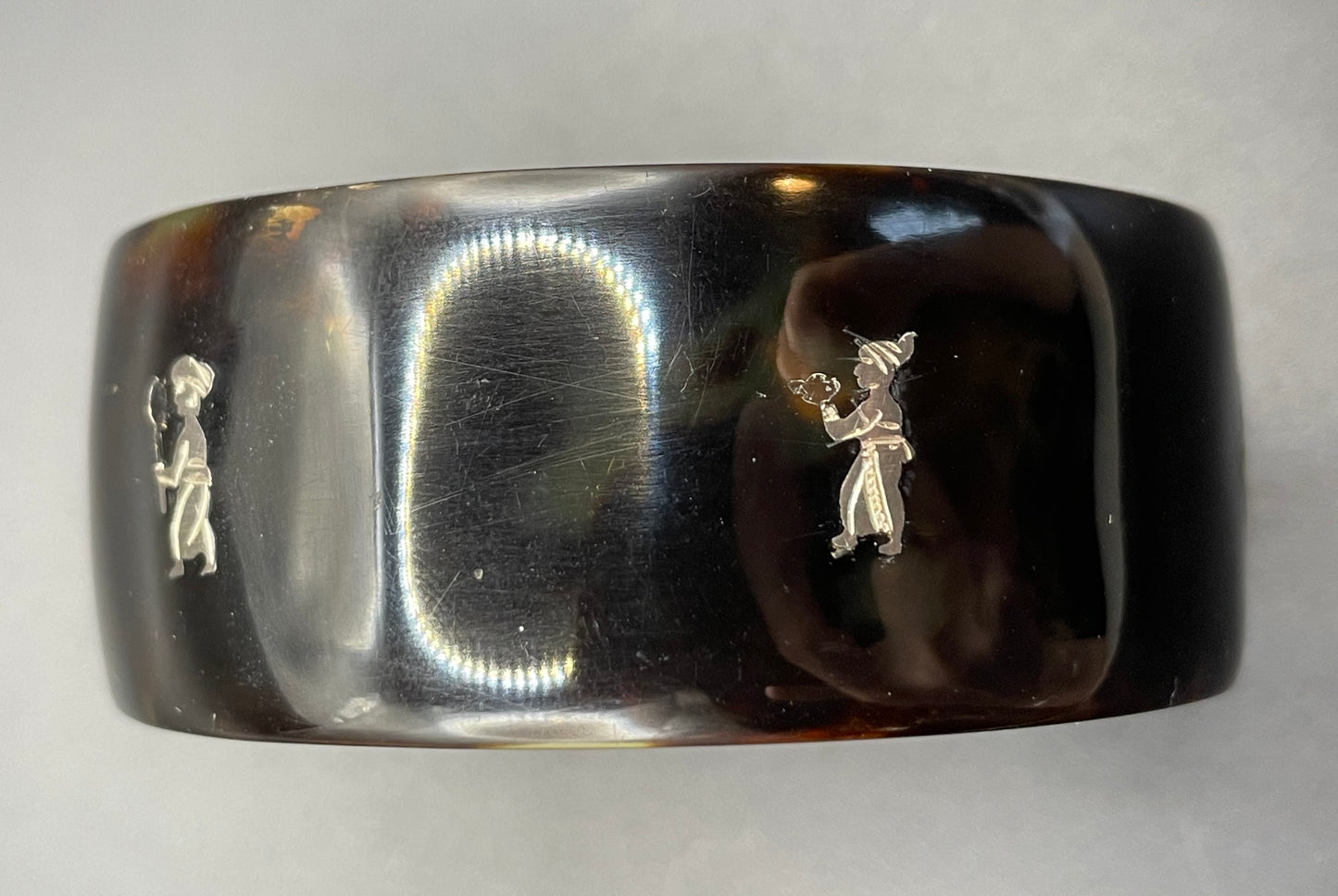 Antique tortoiseshell and silver piqué work bangle, perhaps souvenir of South Asia, figures and an elephant depicted