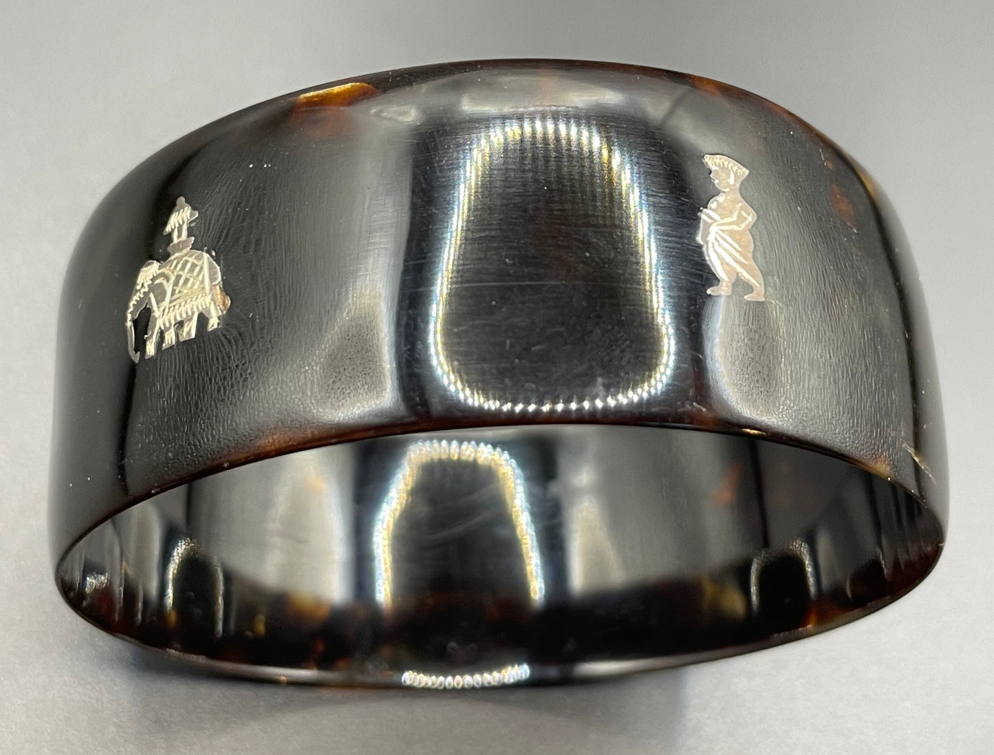 Antique tortoiseshell and silver piqué work bangle, perhaps souvenir of South Asia, figures and an elephant depicted