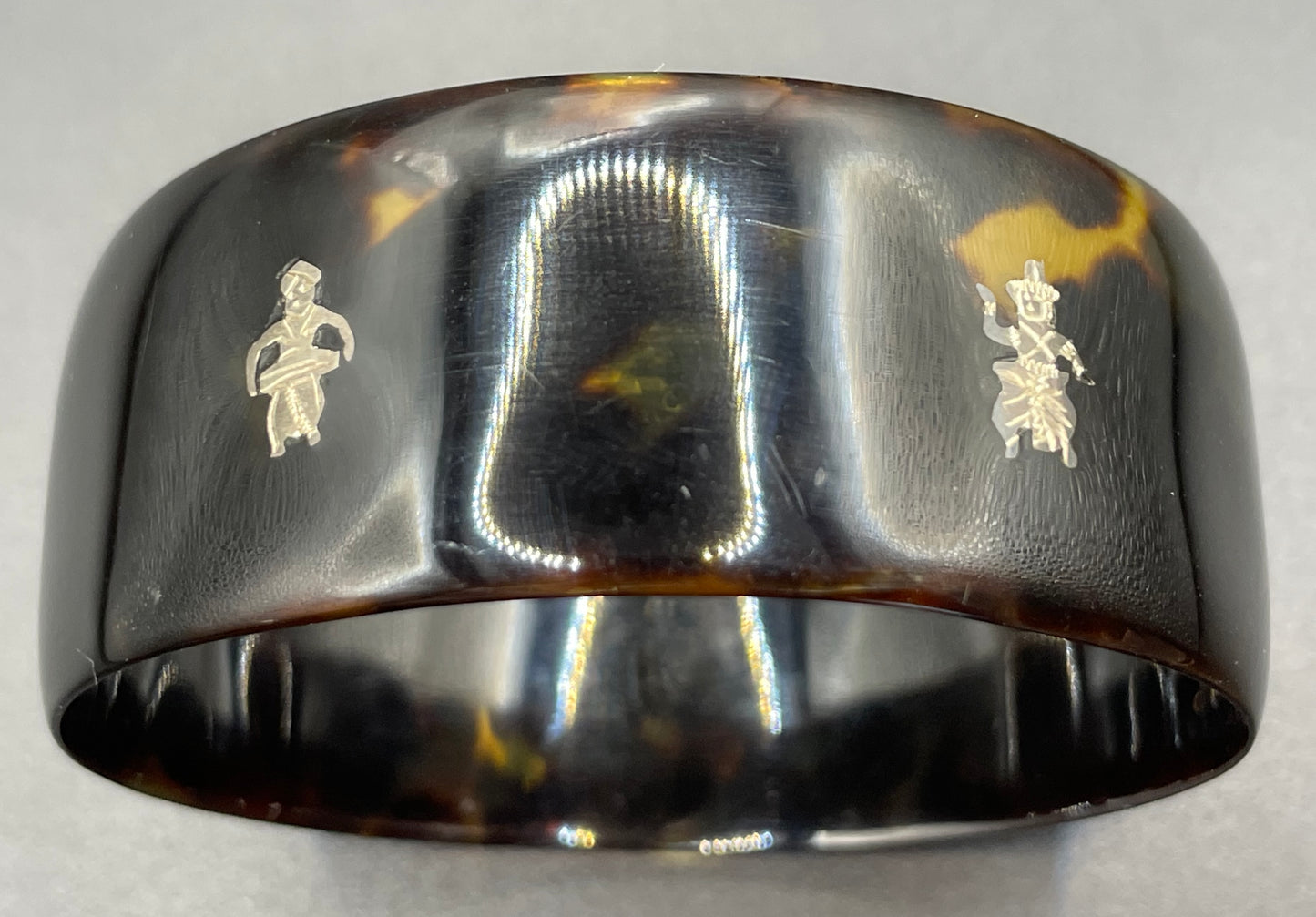Antique tortoiseshell and silver piqué work bangle, perhaps souvenir of South Asia, figures and an elephant depicted