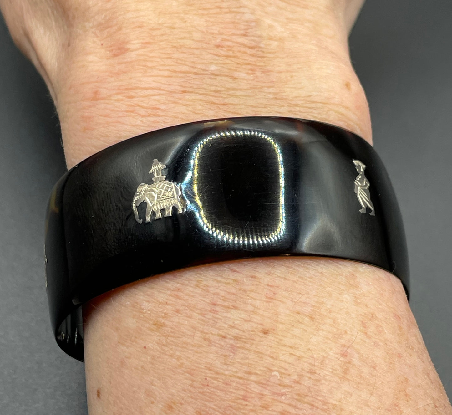 Antique tortoiseshell and silver piqué work bangle, perhaps souvenir of South Asia, figures and an elephant depicted