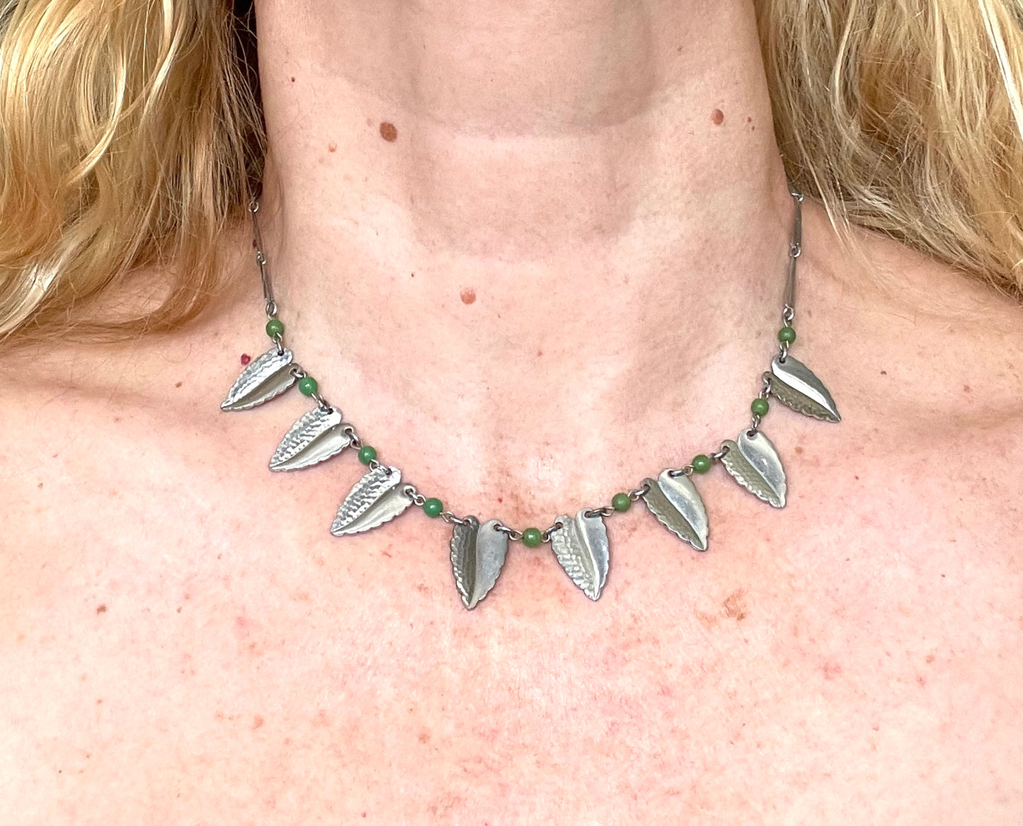 Vintage Jakob Bengel Art Deco machine age necklace, bright green galalith beads with shiny and hammered silver tone chrome leaf fringe