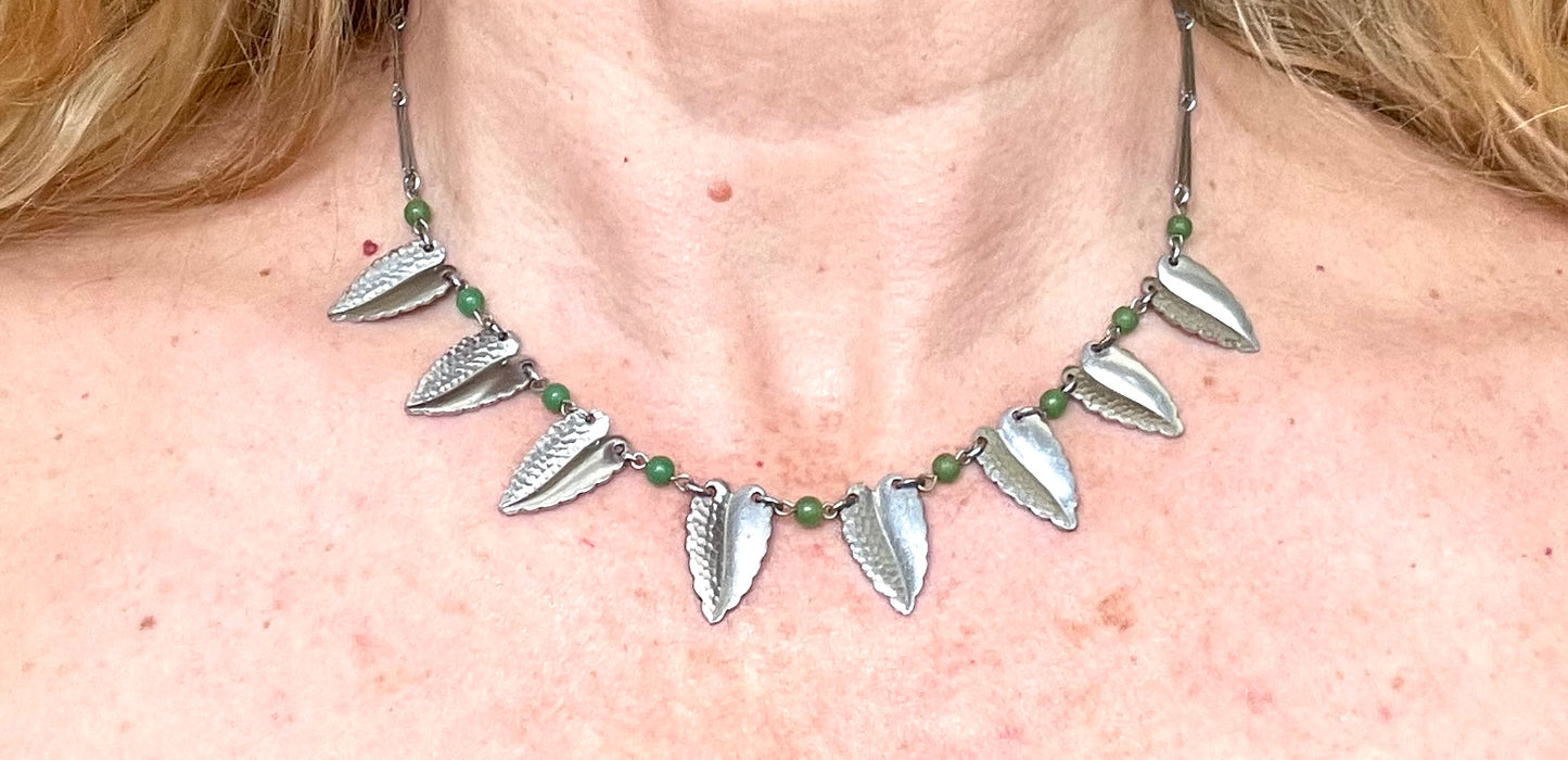 Vintage Jakob Bengel Art Deco machine age necklace, bright green galalith beads with shiny and hammered silver tone chrome leaf fringe