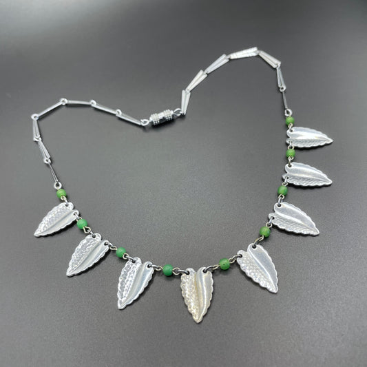 Vintage Jakob Bengel Art Deco machine age necklace, bright green galalith beads with shiny and hammered silver tone chrome leaf fringe