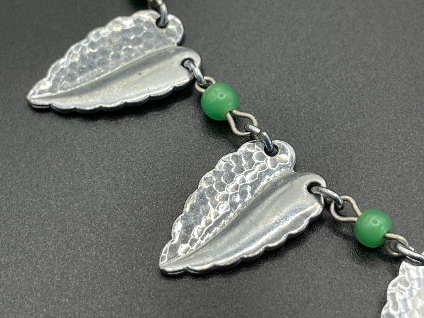 Vintage Jakob Bengel Art Deco machine age necklace, bright green galalith beads with shiny and hammered silver tone chrome leaf fringe