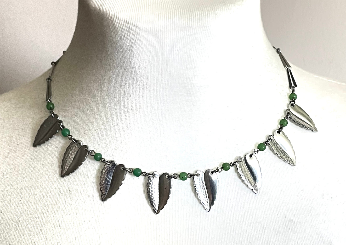Vintage Jakob Bengel Art Deco machine age necklace, bright green galalith beads with shiny and hammered silver tone chrome leaf fringe