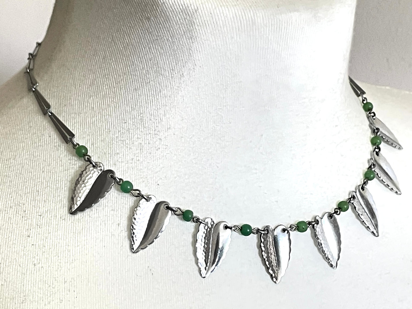 Vintage Jakob Bengel Art Deco machine age necklace, bright green galalith beads with shiny and hammered silver tone chrome leaf fringe