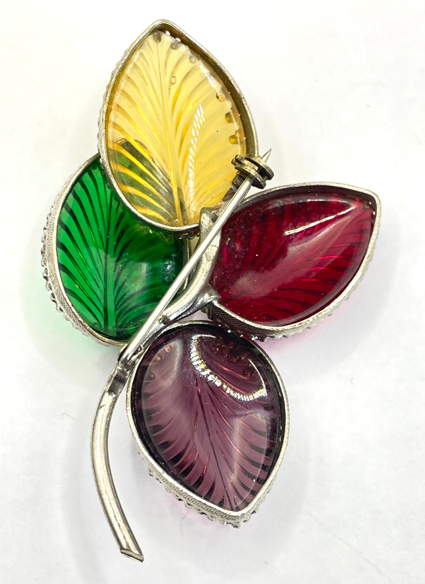 Vintage unsigned Schreiner ? pressed glass cabochon leaf brooch set in silver tone, vibrant red, yellow, green and purple crystals