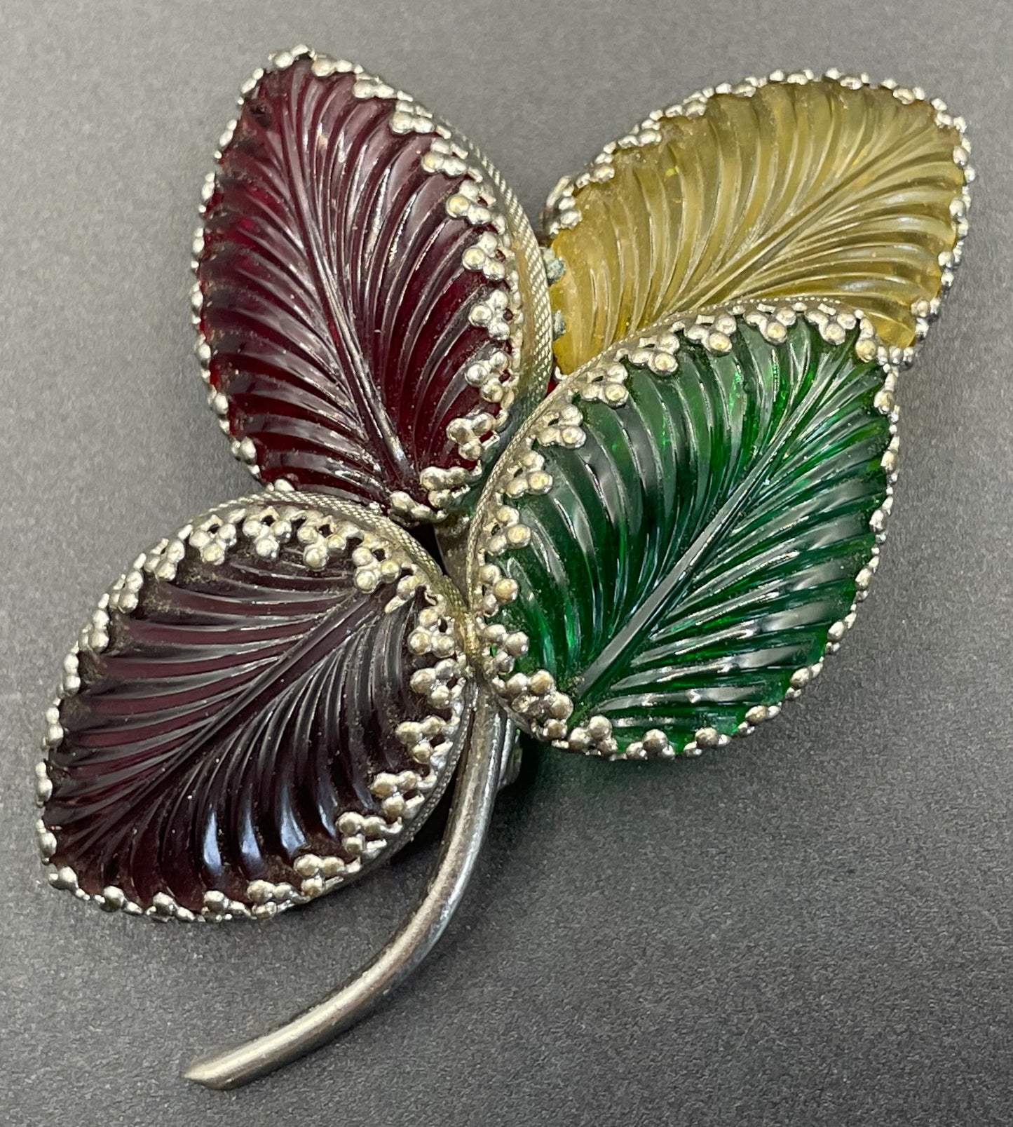 Vintage unsigned Schreiner ? pressed glass cabochon leaf brooch set in silver tone, vibrant red, yellow, green and purple crystals