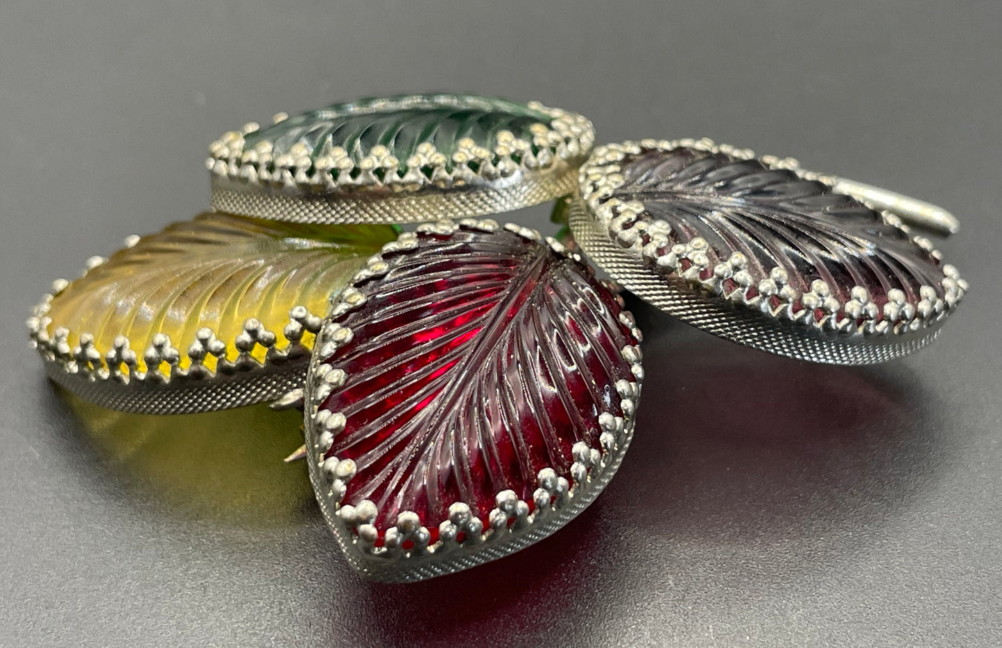 Vintage unsigned Schreiner ? pressed glass cabochon leaf brooch set in silver tone, vibrant red, yellow, green and purple crystals