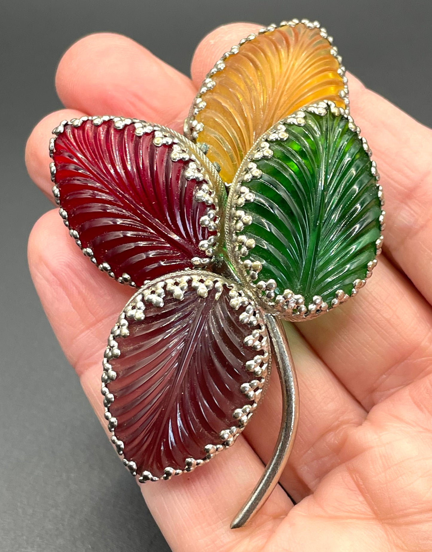 Vintage unsigned Schreiner ? pressed glass cabochon leaf brooch set in silver tone, vibrant red, yellow, green and purple crystals