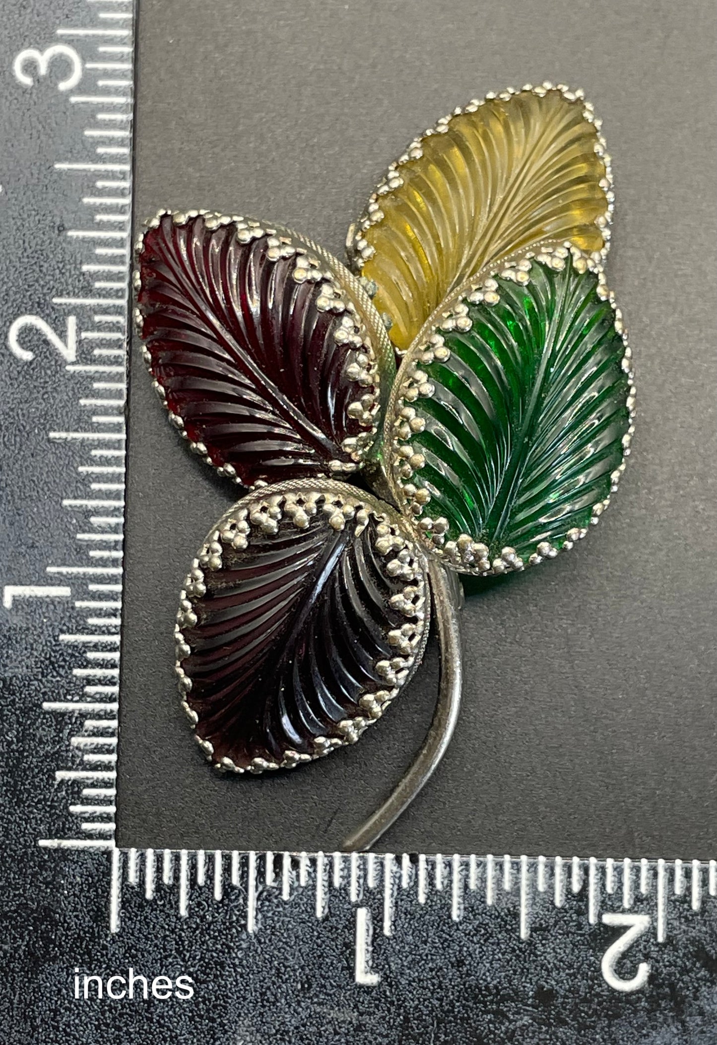 Vintage unsigned Schreiner ? pressed glass cabochon leaf brooch set in silver tone, vibrant red, yellow, green and purple crystals