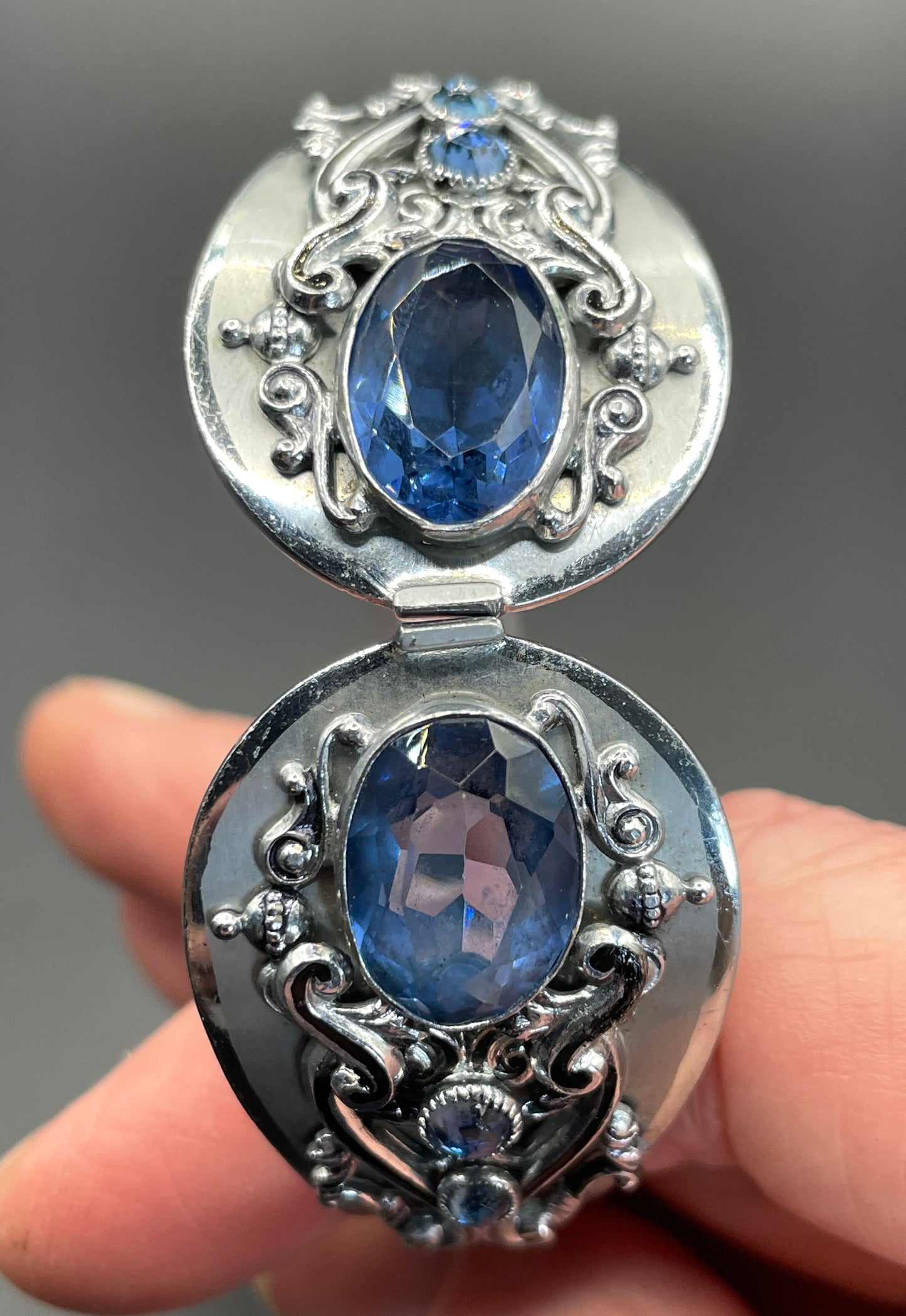 Vintage Neiger brothers sapphire blue rhinestone ornate Art Deco hinged clamper bangle set in silver tone with black enamel accents