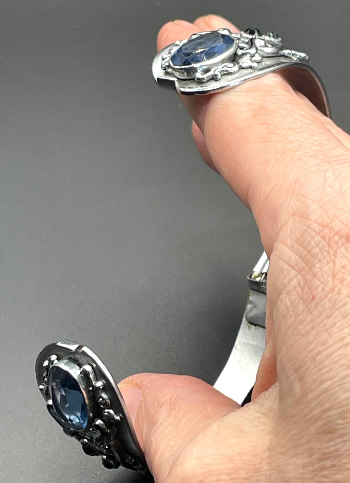 Vintage Neiger brothers sapphire blue rhinestone ornate Art Deco hinged clamper bangle set in silver tone with black enamel accents