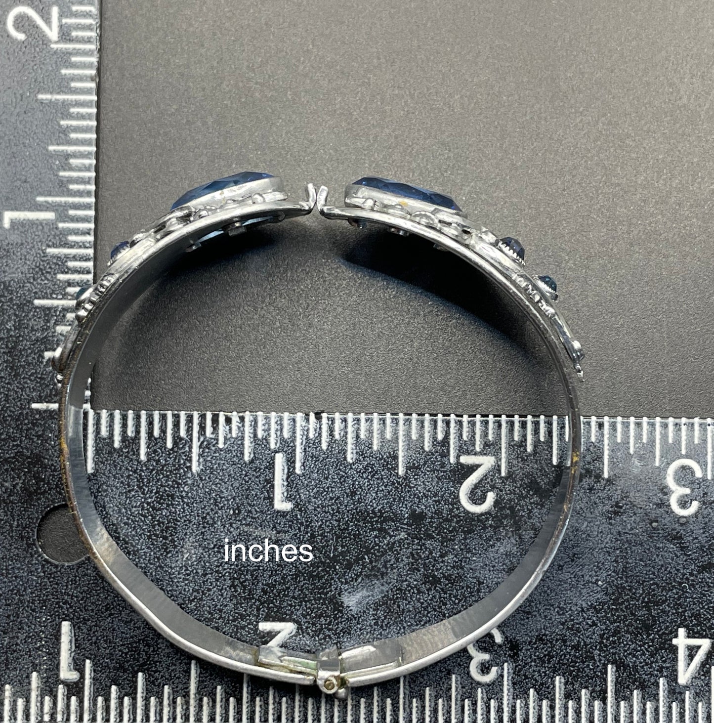 Vintage Neiger brothers sapphire blue rhinestone ornate Art Deco hinged clamper bangle set in silver tone with black enamel accents